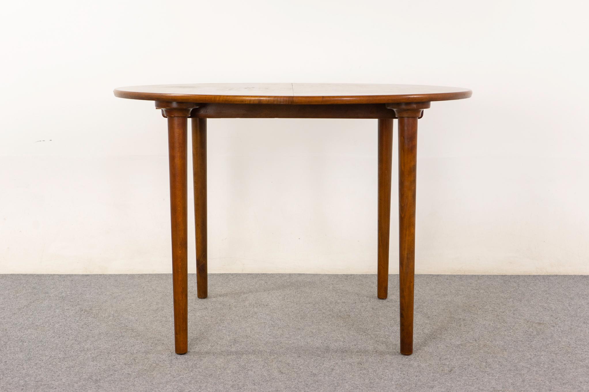 Walnut Danish dining table, circa 1950s. Bookmatched veneer top and solid legs. Extendable design, add in the leaves when required. Original leaves are maple.

43.5