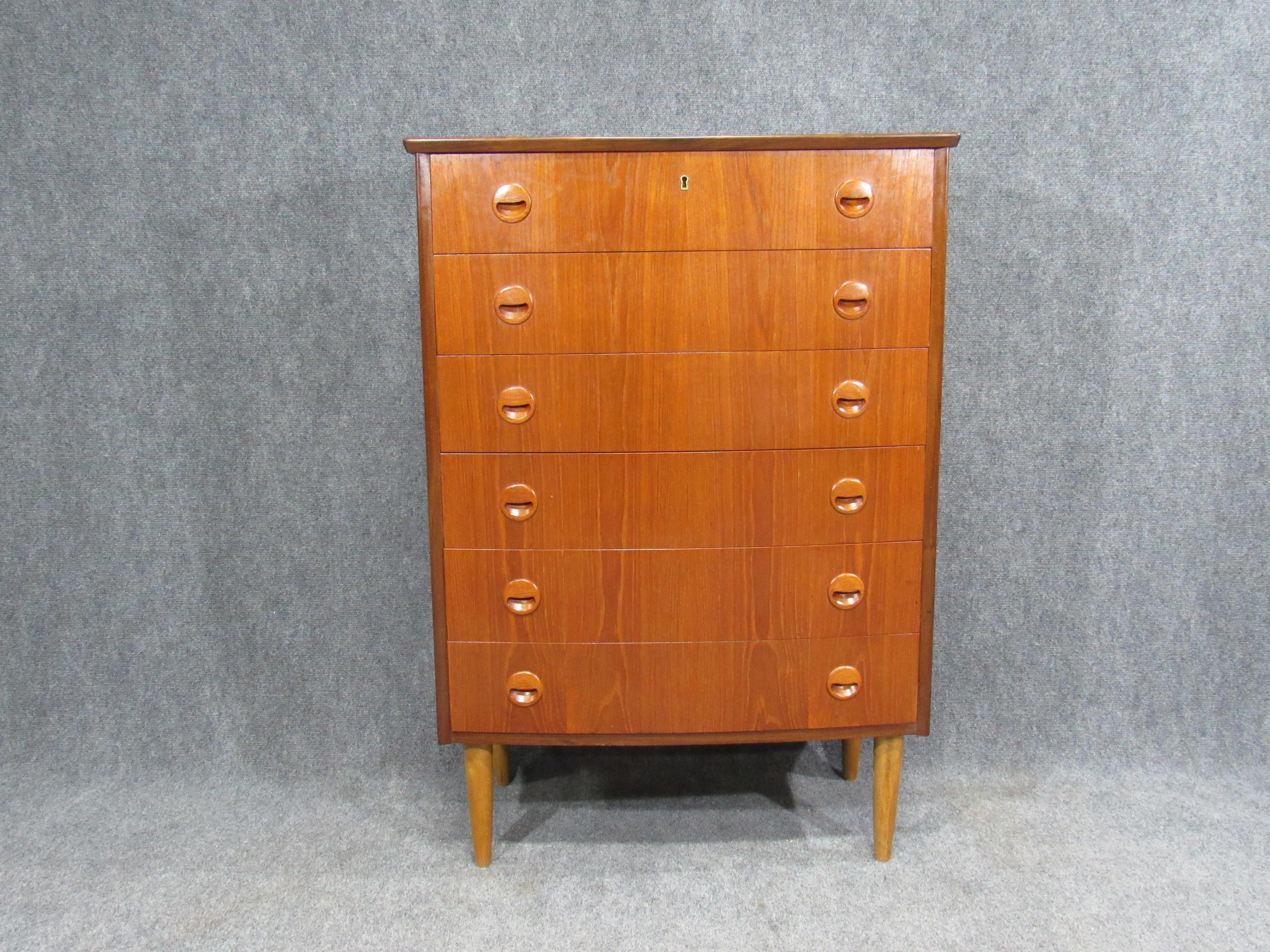 Mid-century Danish modern teak dresser / chest of drawers with elegant rounded front. Original drawer lock key is provided with the piece.
