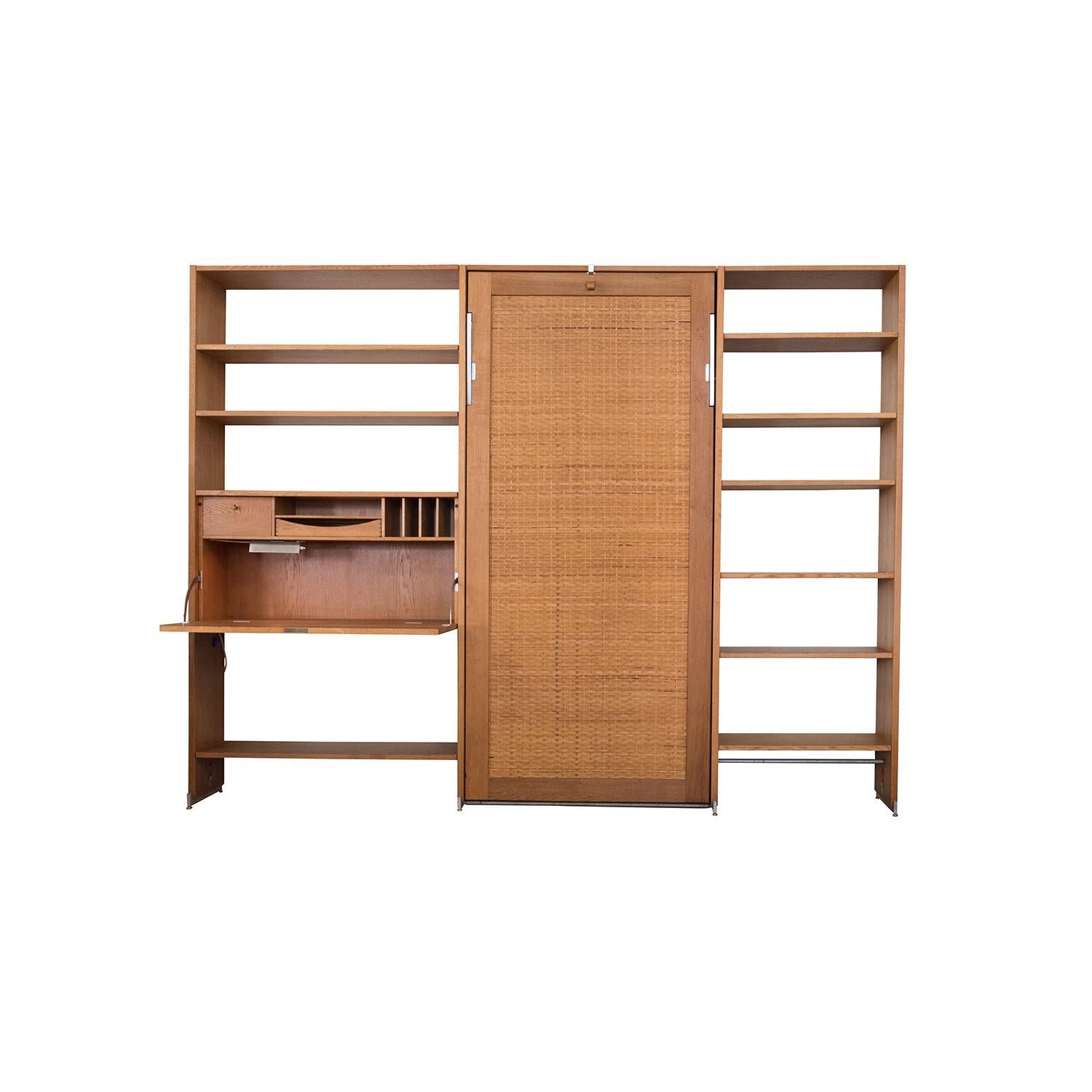Danish Modern RY100 Murphy bed secretary and shelving system by Hans J Wegner for Ry. This Classic Murphy bed boasts a lovely cane front with heavyweight steel hardware and drop down bed upholstered in original Danish wool (we'll replace the wool in