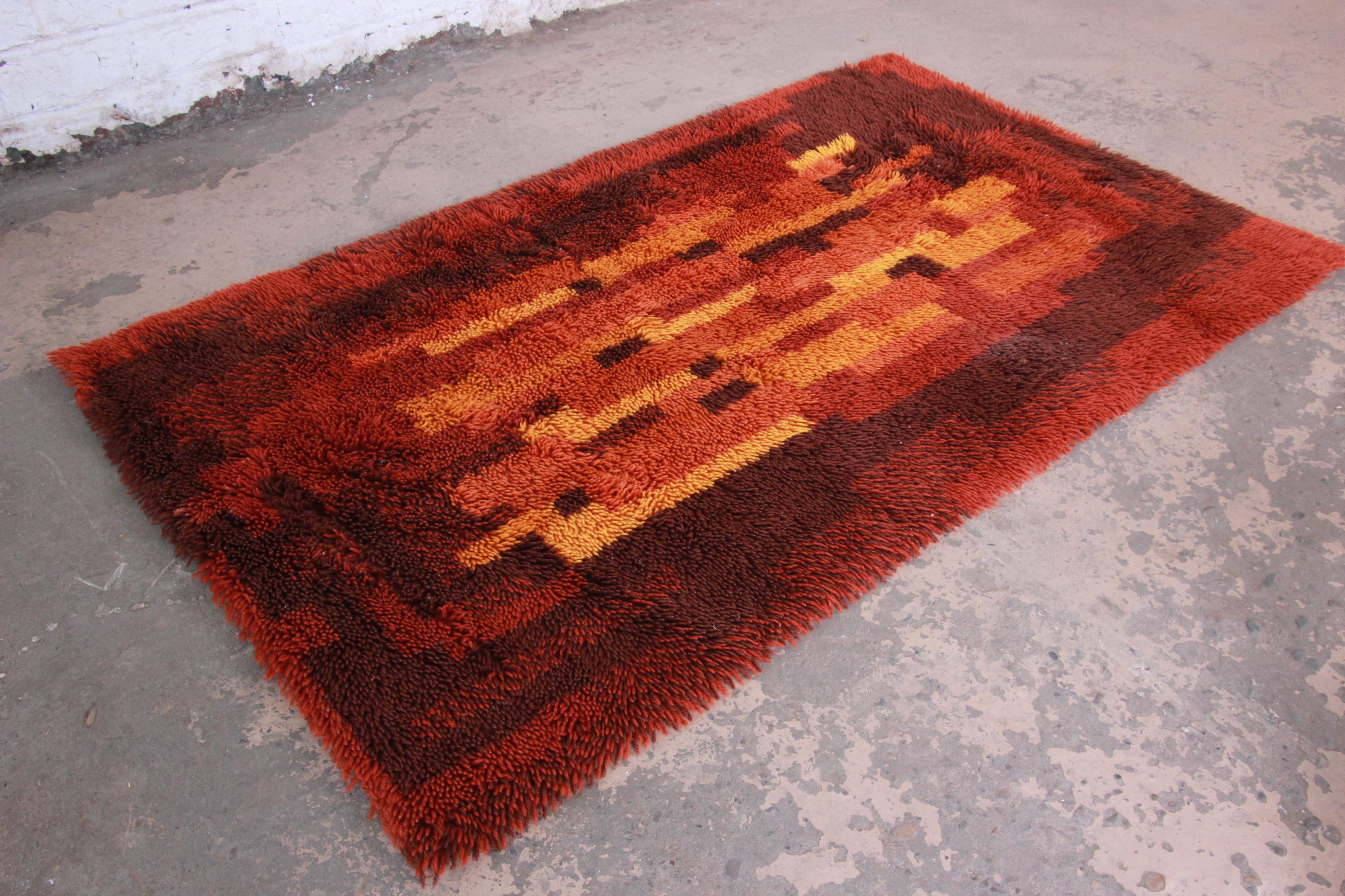A gorgeous midcentury Danish modern rya shag rug. The rug has a unique abstract design, with vivid colors in red, orange, and yellow. It has a thick wool pile and is in very good vintage condition. Measures: 3'1