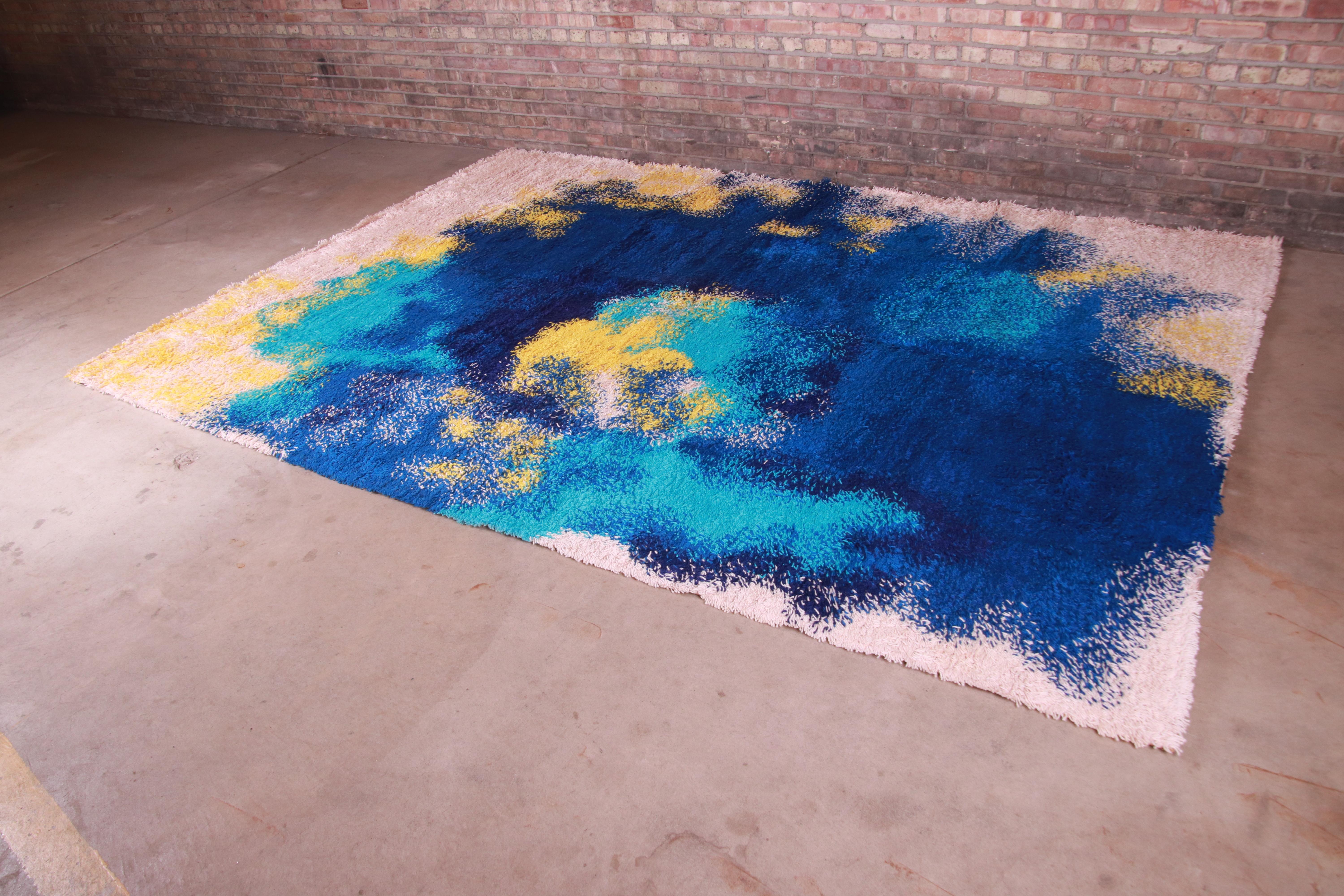An outstanding mid-century Danish Modern Rya shag wool rug

By Galaxy Collection

Denmark, 1970s

Thick wool pile, with vibrant colors blues, yellow, and ivory.

Measures: 8'2