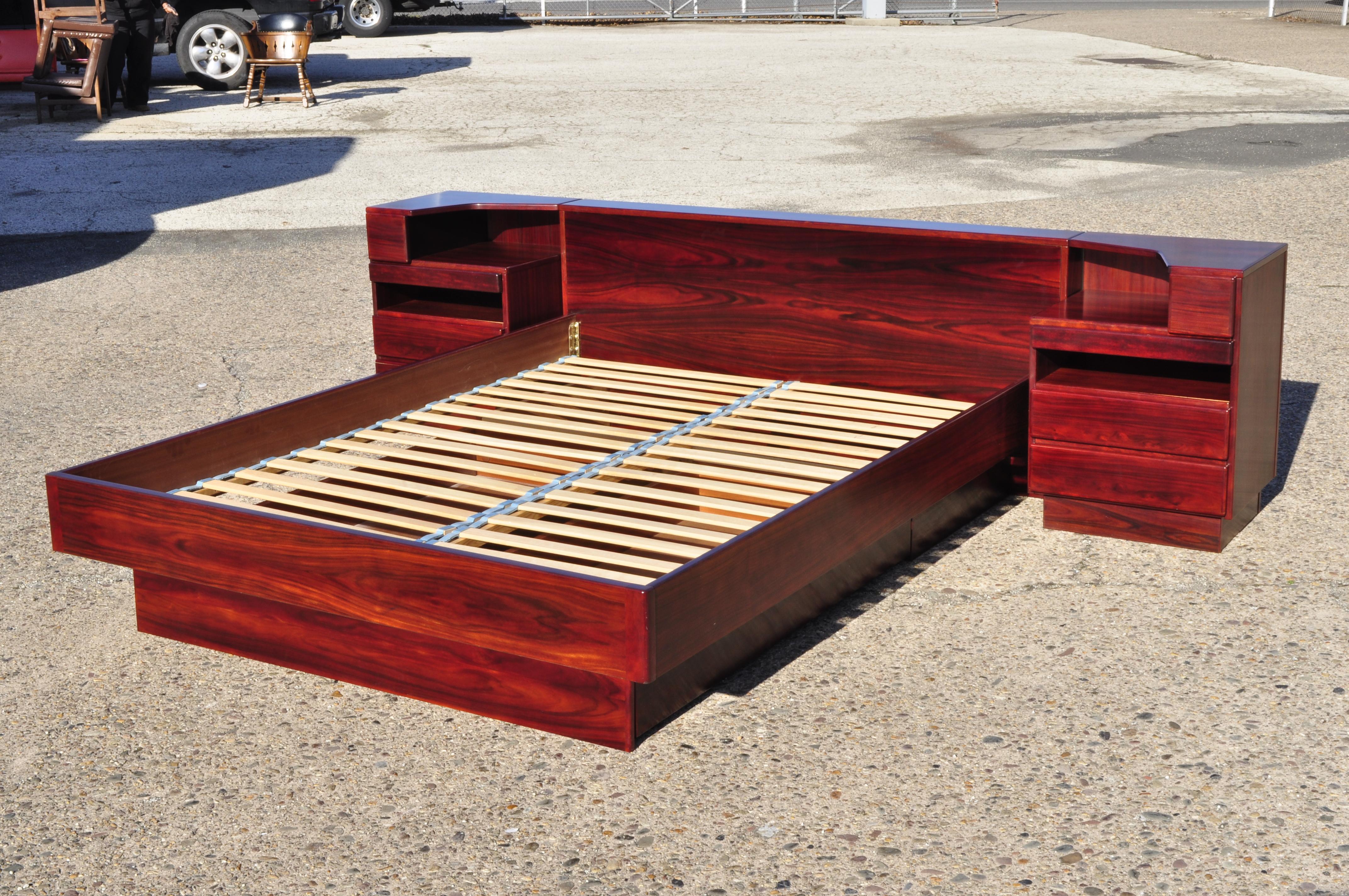Danish modern scan coll rosewood queen platform storage bed and pair nightstands. Listing includes a bed frame with 2 pull out storage drawers, 3 drawers to nightstands, 1 pull out with sliding surface (see pic), finished backs, angled tops to