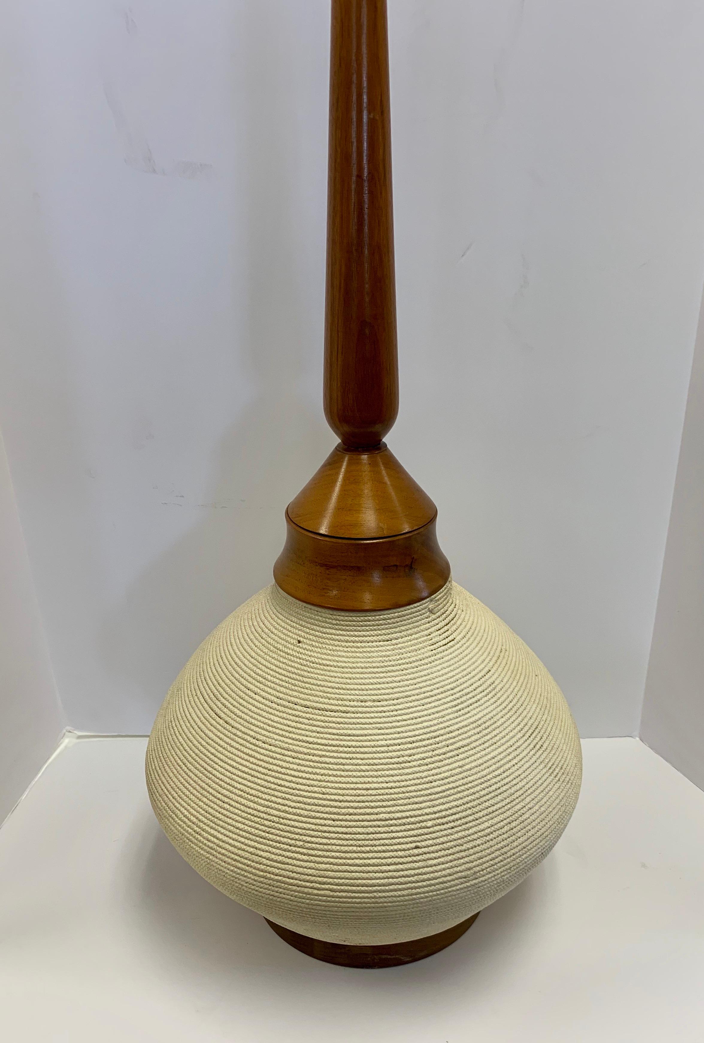 A true statement piece, Scandinavian Modern tall table lamp. The white body looks like ropes in a circle but is actually ceramic carvings. Wired for USA and in perfect working order.