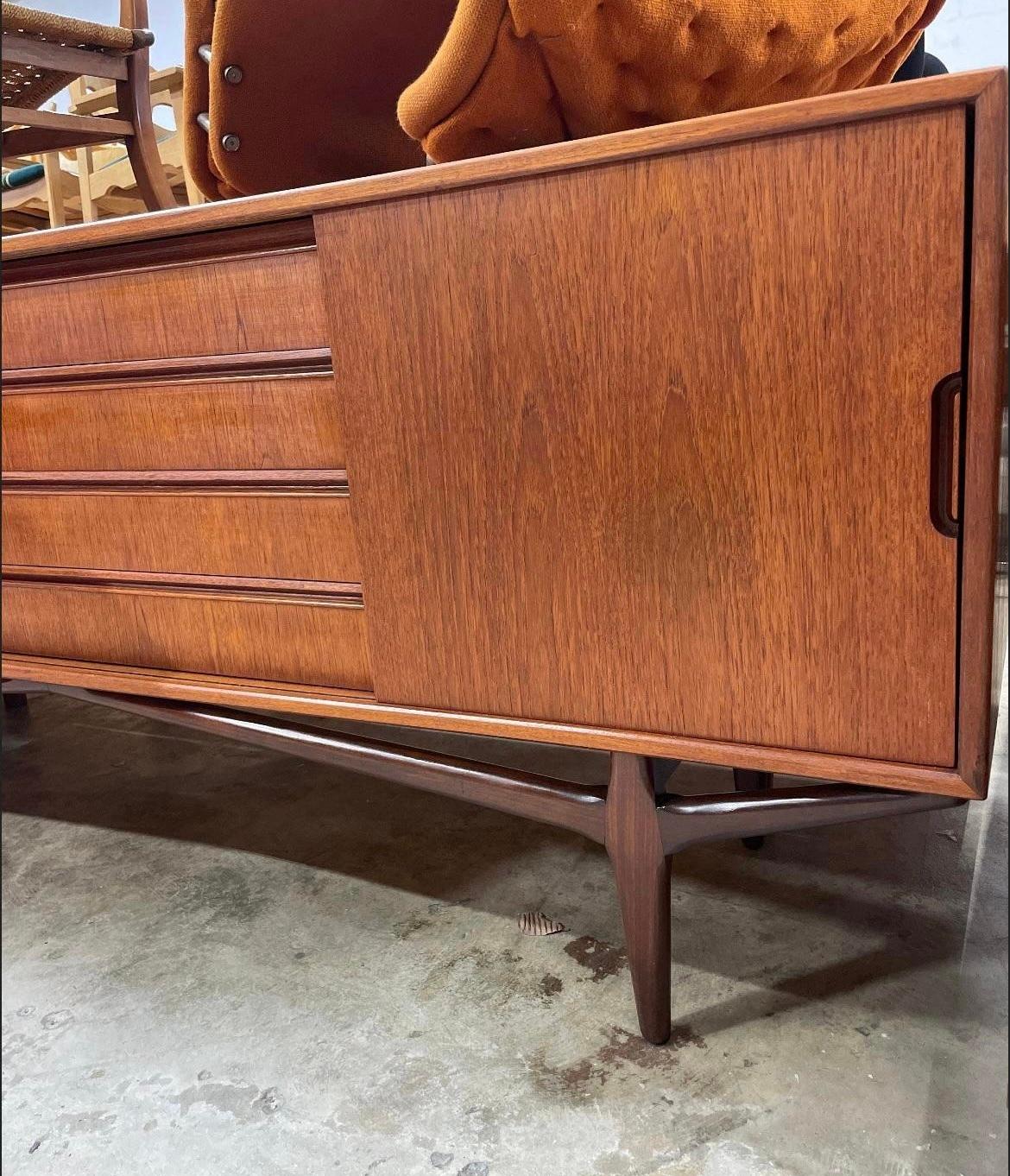 Danish Modern Teak Console or Credenza with Sculptural legs. Drawers on middle and one shelf behind each door.