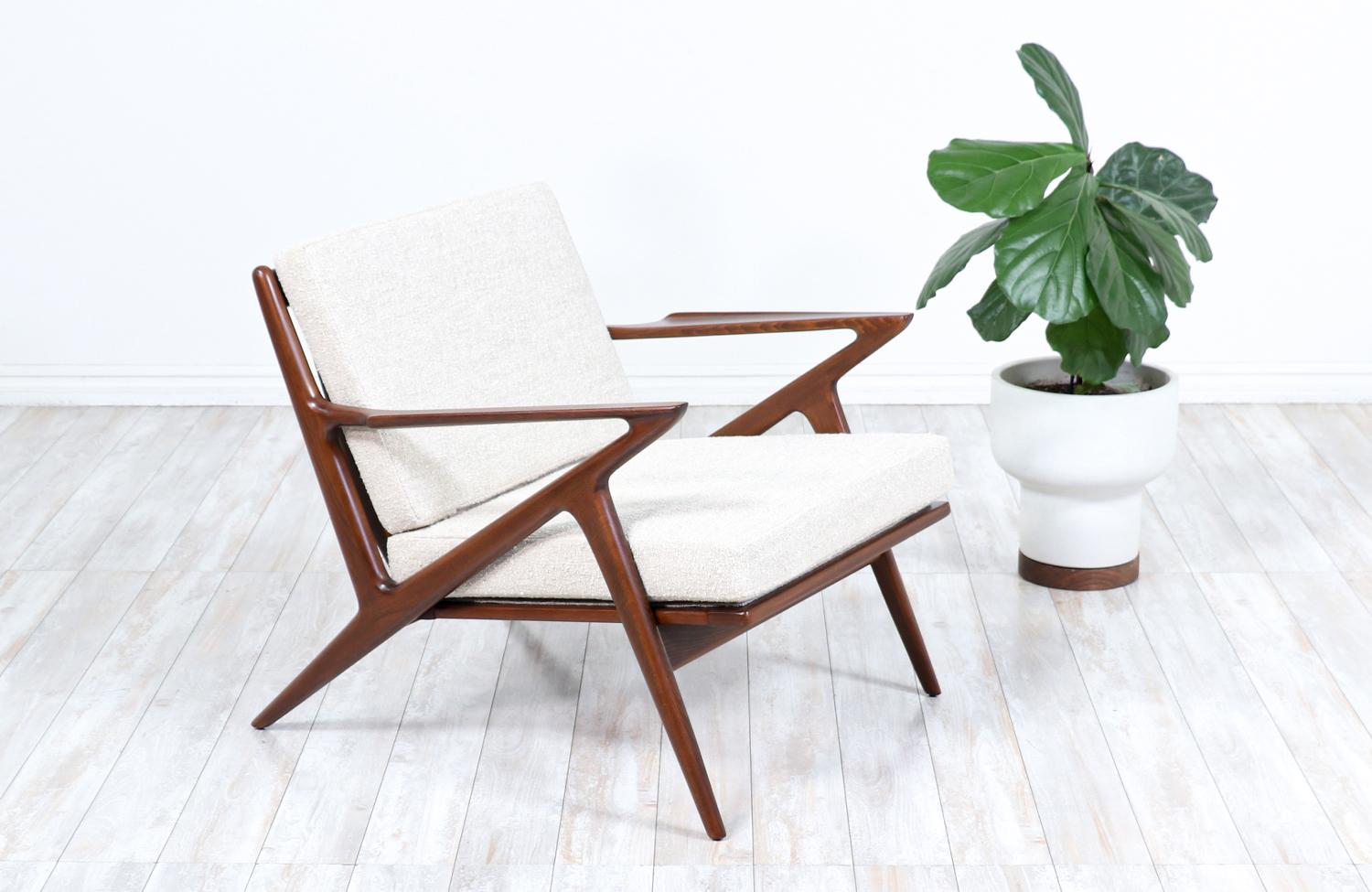 A classic lounge chair designed by Poul Jensen for Selig in Denmark circa 1950s. Known as the 'Z' lounge chair for its signature armrests that connect to the legs, which resembles the letter. This iconic chair features a solid walnut-stained