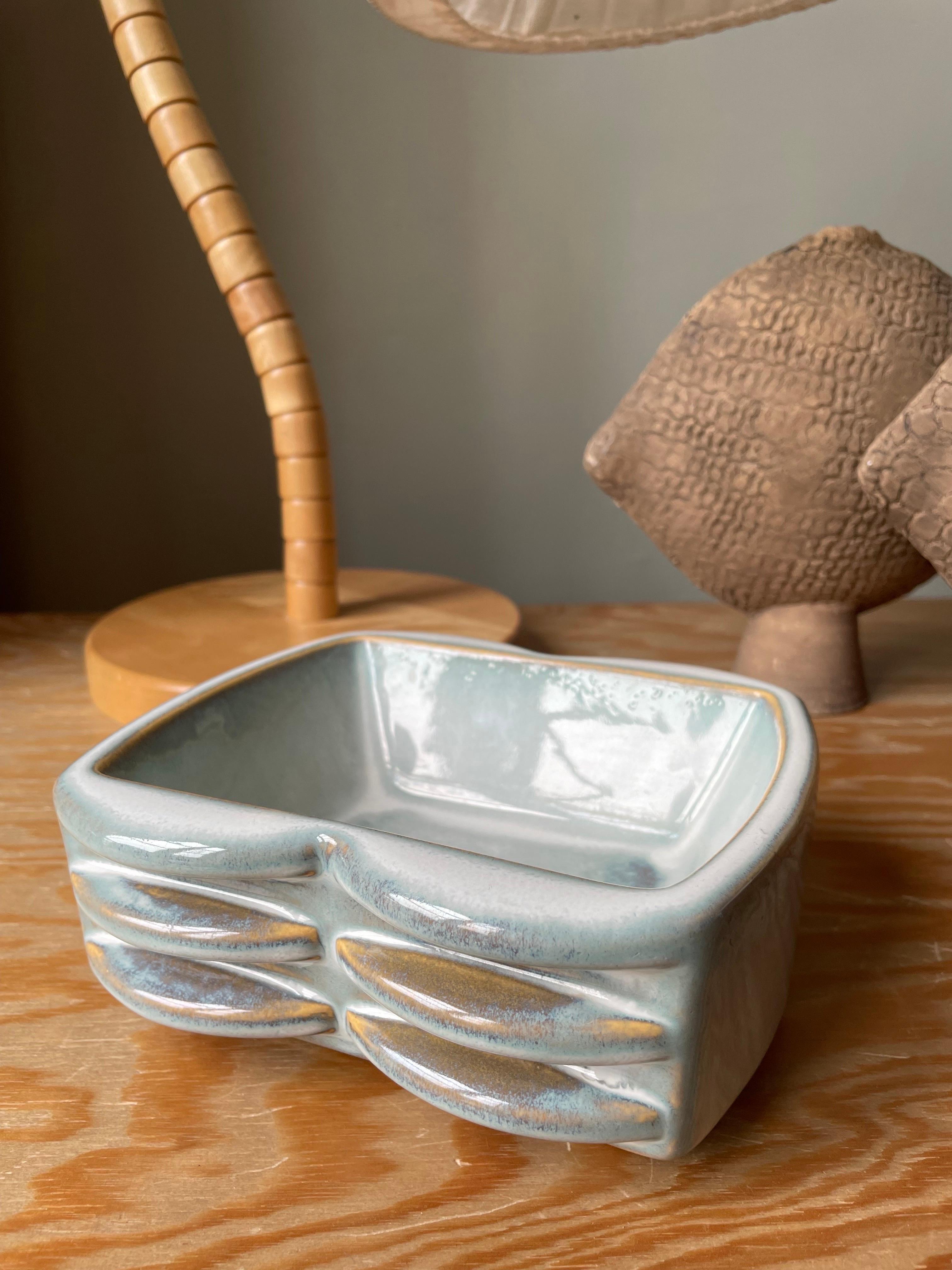 Light blue handmade ceramic Danish midcentury modern decorative vide poche bowl by Einar Johansen for Søholm. Square and soft graphic relief shapes glazed in a dusty light blue and caramel colors. Manufactured at the island of Bornholm in the early