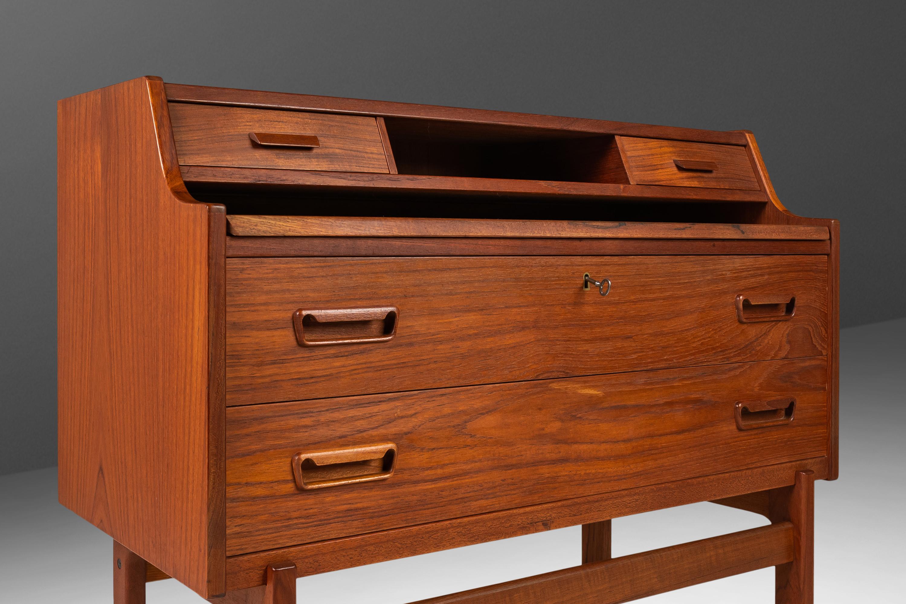 Ideal for collectors limited on space but unwilling to compromise on style and functionality this splendid secretary desk, designed by the influential Arne Wahl Iversen, is the quintessential example of Danish Modern design. Constructed in teak with