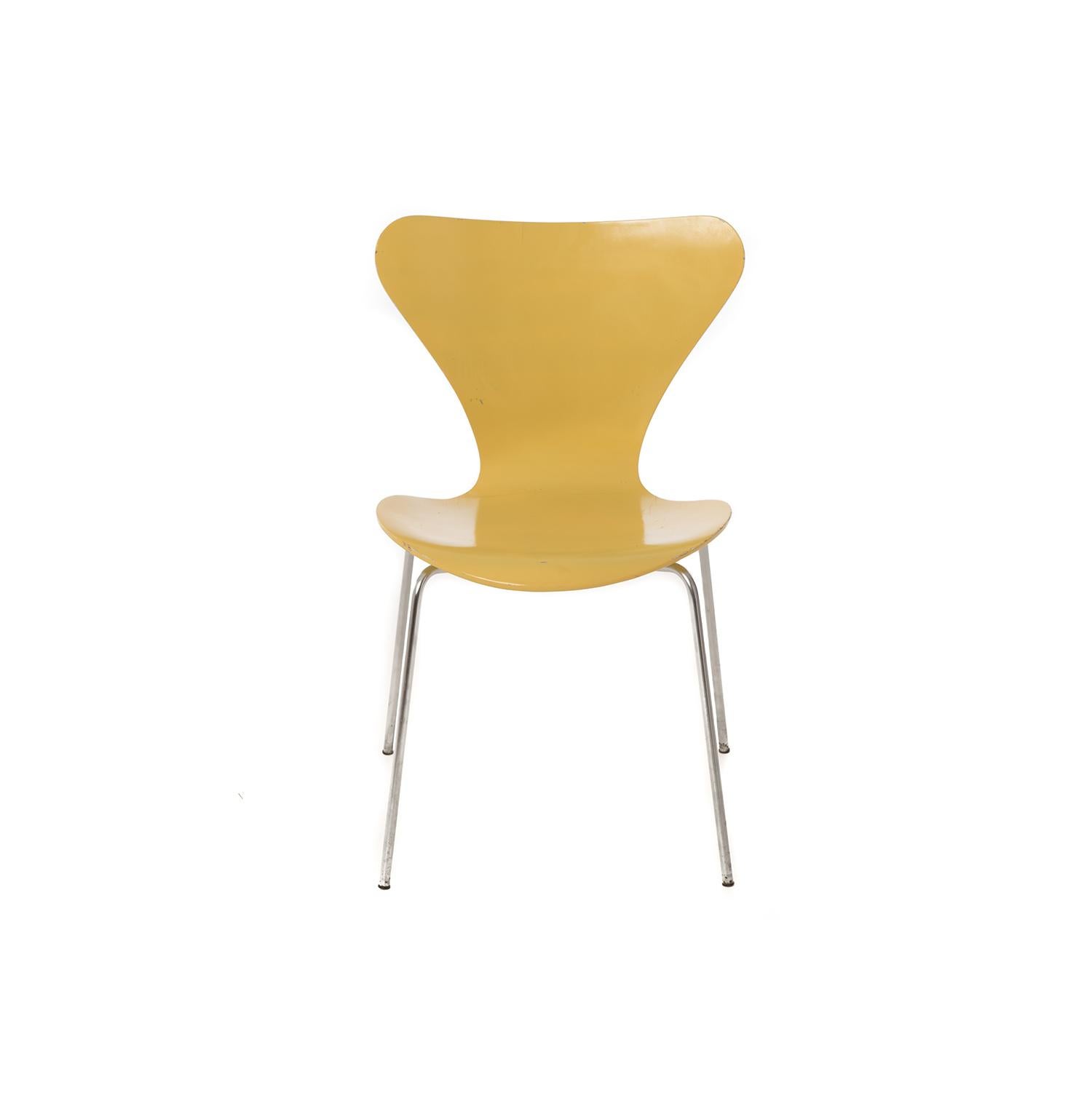 These Classic chairs are a cheery shade of yellow! This is a 4 legged chair, metal legs, designed by Arne Jacobsen in 1951. The first chair designed for the mass market-- easy to transport... across the ocean and in your home. Plus it's comfortable