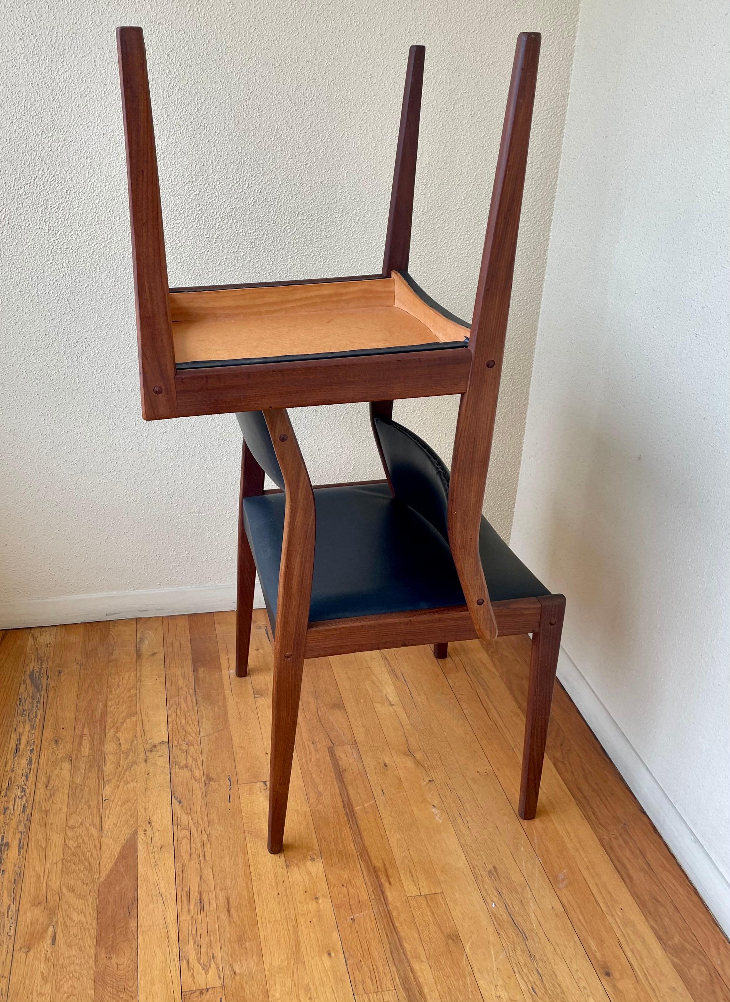 Great set of four solid teak frames dining chairs circa the 1970s, great condition black Naugahyde seat, and back, solid and sturdy. We have cleaned and oiled each chair in great original condition.