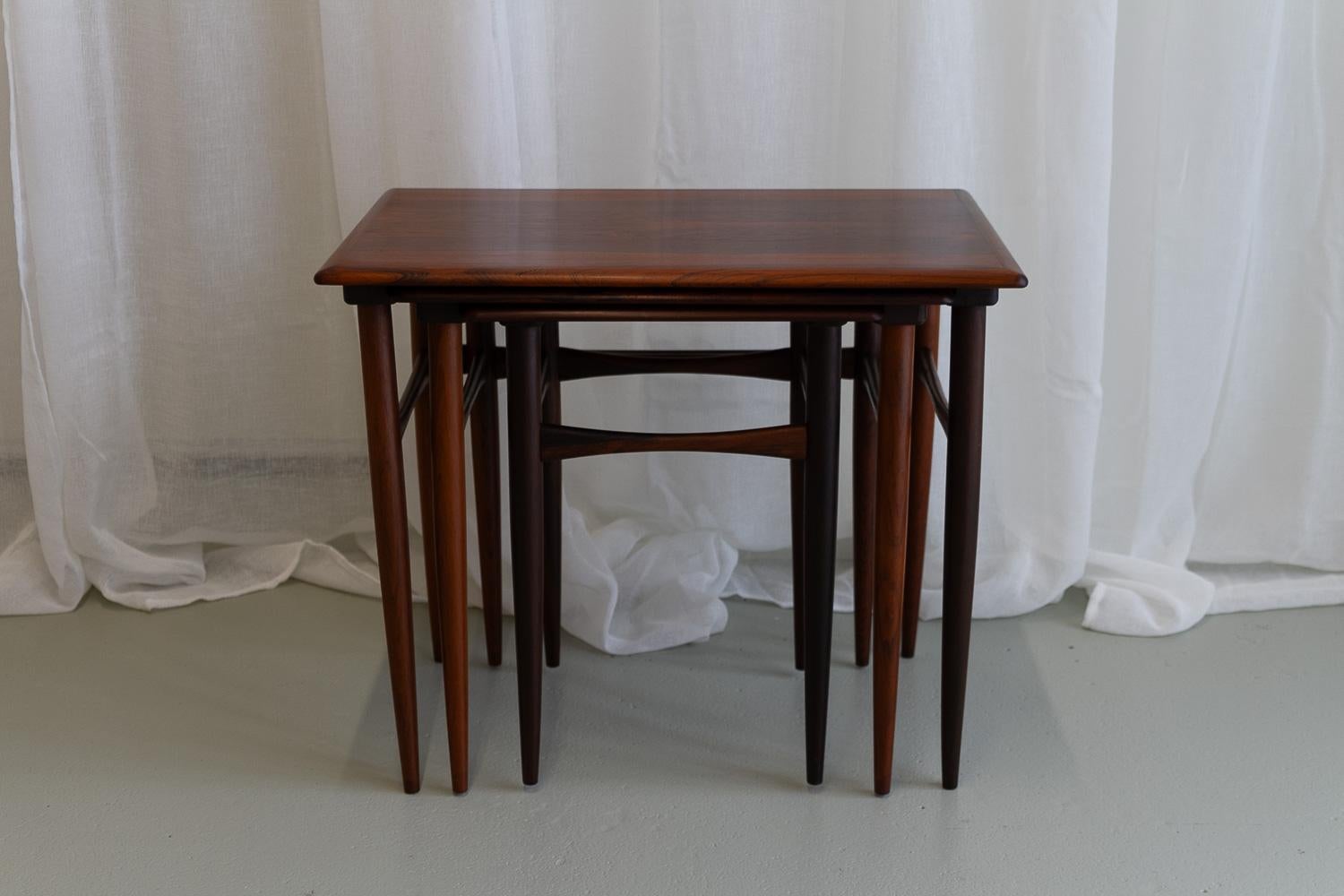 Danish Modern Set of Rosewood Nesting Tables, 1960s.
Set of three Scandinavian Modern Rosewood/Palisander nesting tables with tapered legs and beautiful expressive veneer pattern.
These light and elegant stacking tables are attributed to Poul