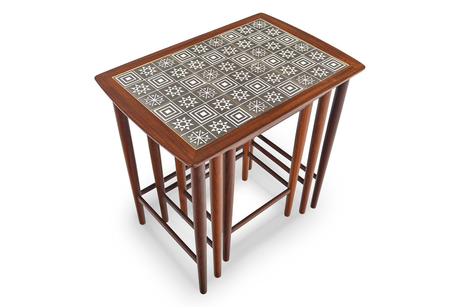 This whimsical set of Danish modern nesting tables in teak will be the perfect addition to any modern home. Each table is adorned with Scandinavian designed “snowflake” tiles. Perfect for stress- free serving and entertaining! In excellent original