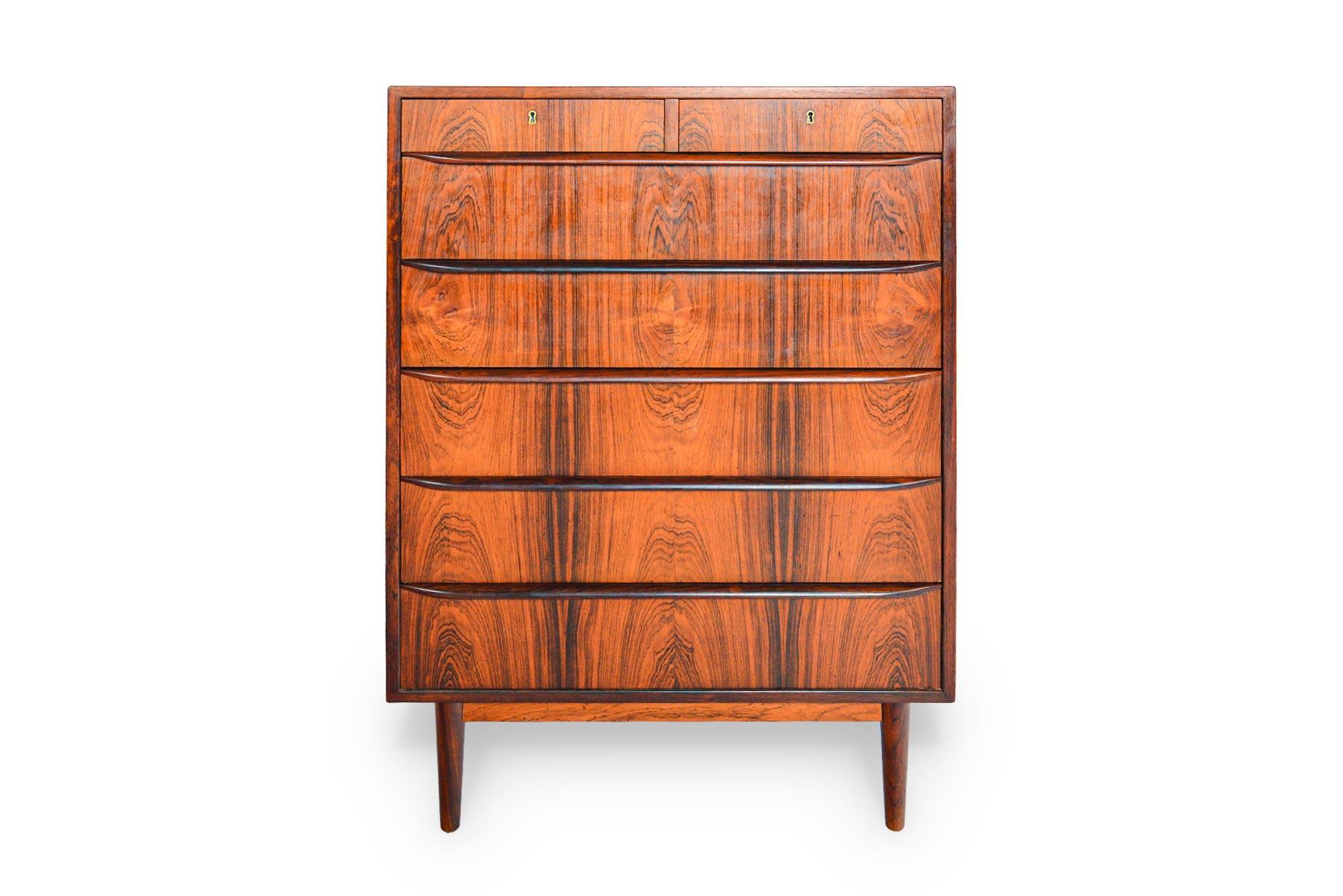 This gorgeous Danish modern seven-drawer midcentury rosewood dresser offers an elegant storage solution. Top drawers are split and accessible by key. Rich woodgrain and high quality construction define this Classic piece. In excellent original