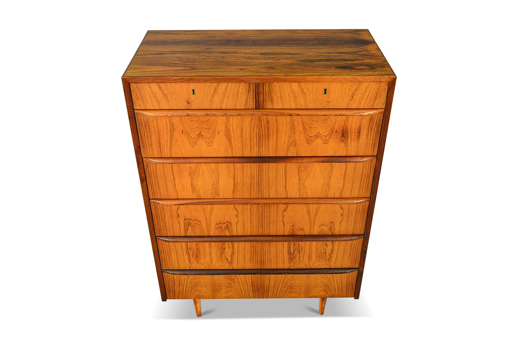 This gorgeous Danish modern seven drawer mid century rosewood dresser offers an elegant storage solution. Top drawers are split and accessible by key. Rich woodgrain and high quality construction define this classic piece. In excellent original