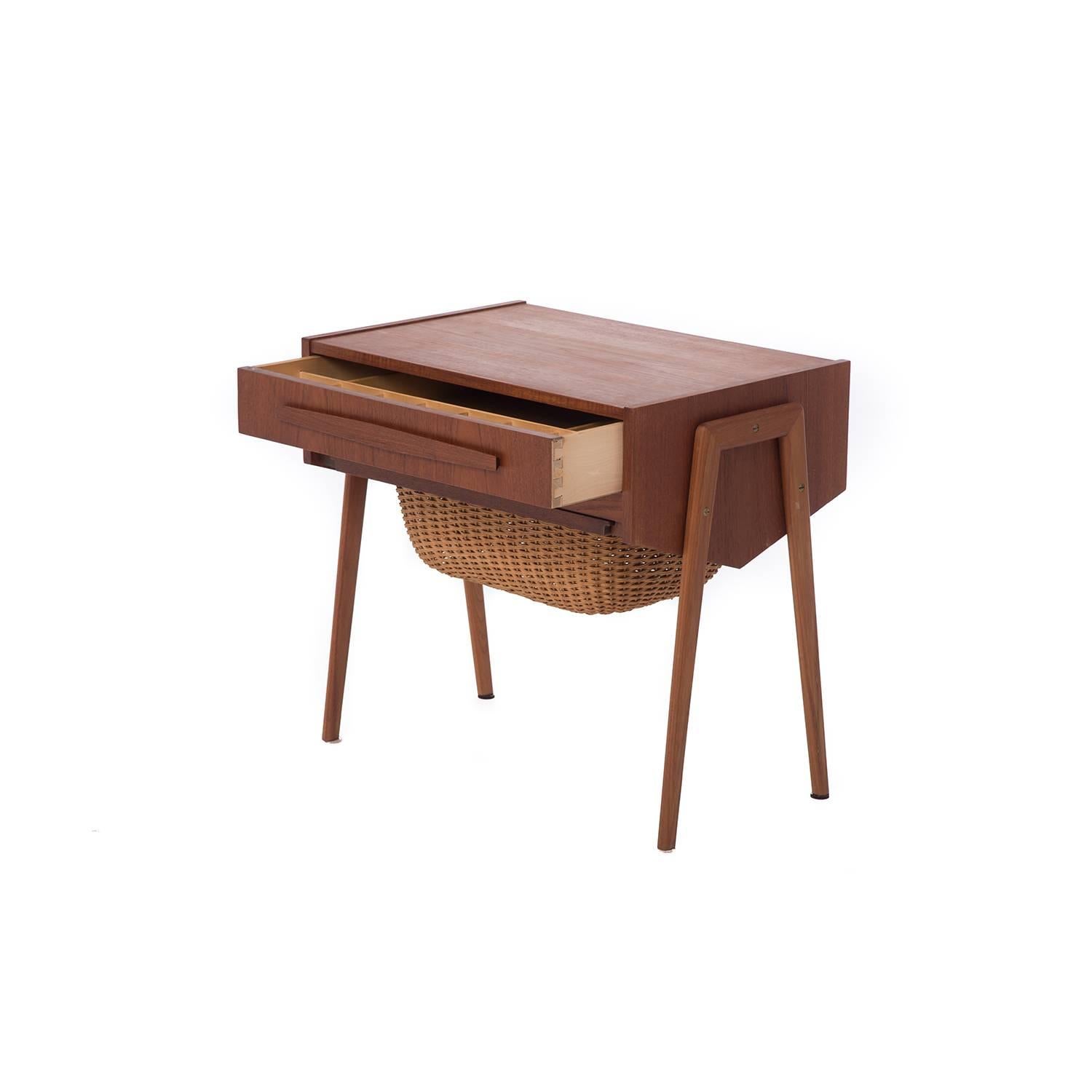 This teak sewing table feature bi-Directional sliding organizer drawer and independently sliding cane basket. Two available (think nightstands)! Sold separately.