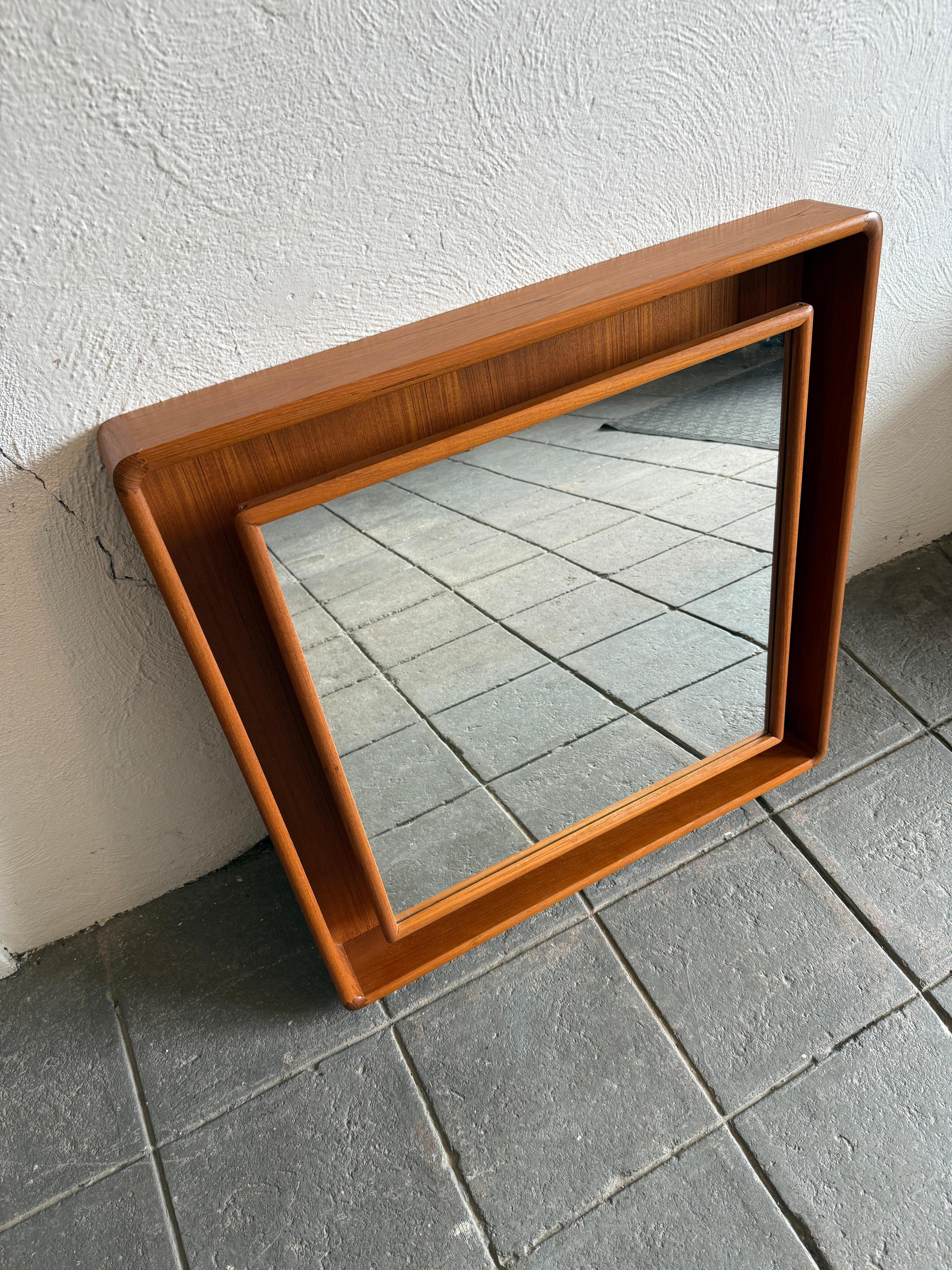 Teak shadow box illuminated Square wall mirror by Pedersen & Hansen Made in Denmark circa 1960s. Gorgeous teak wood grain throughout the rectangular frames with finger joints. Stunning in person. Mirror glass is in excellent condition with no flaws.