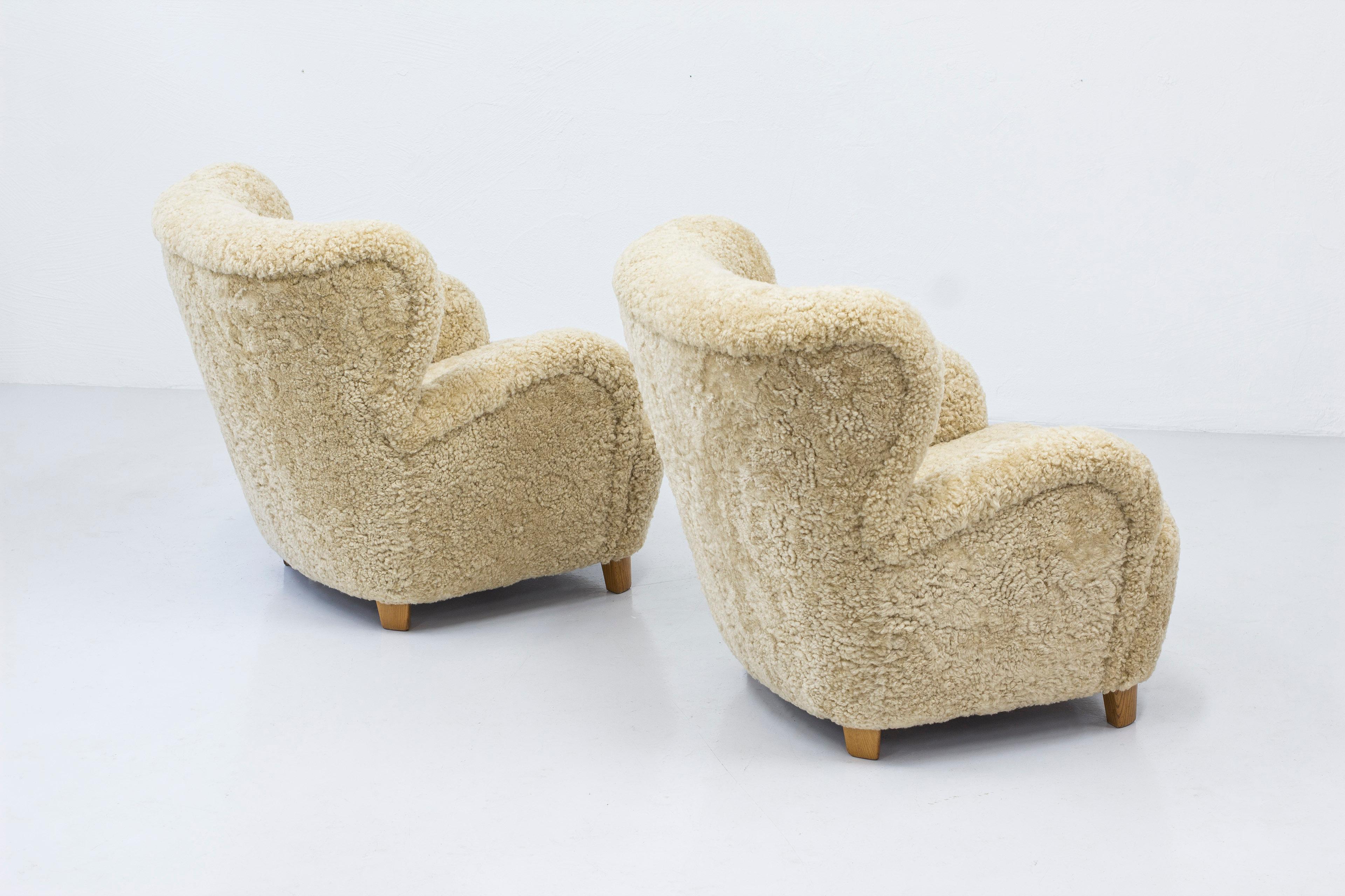 Danish modern sheepskin lounge chairs in the style of Flemming Lassen 4