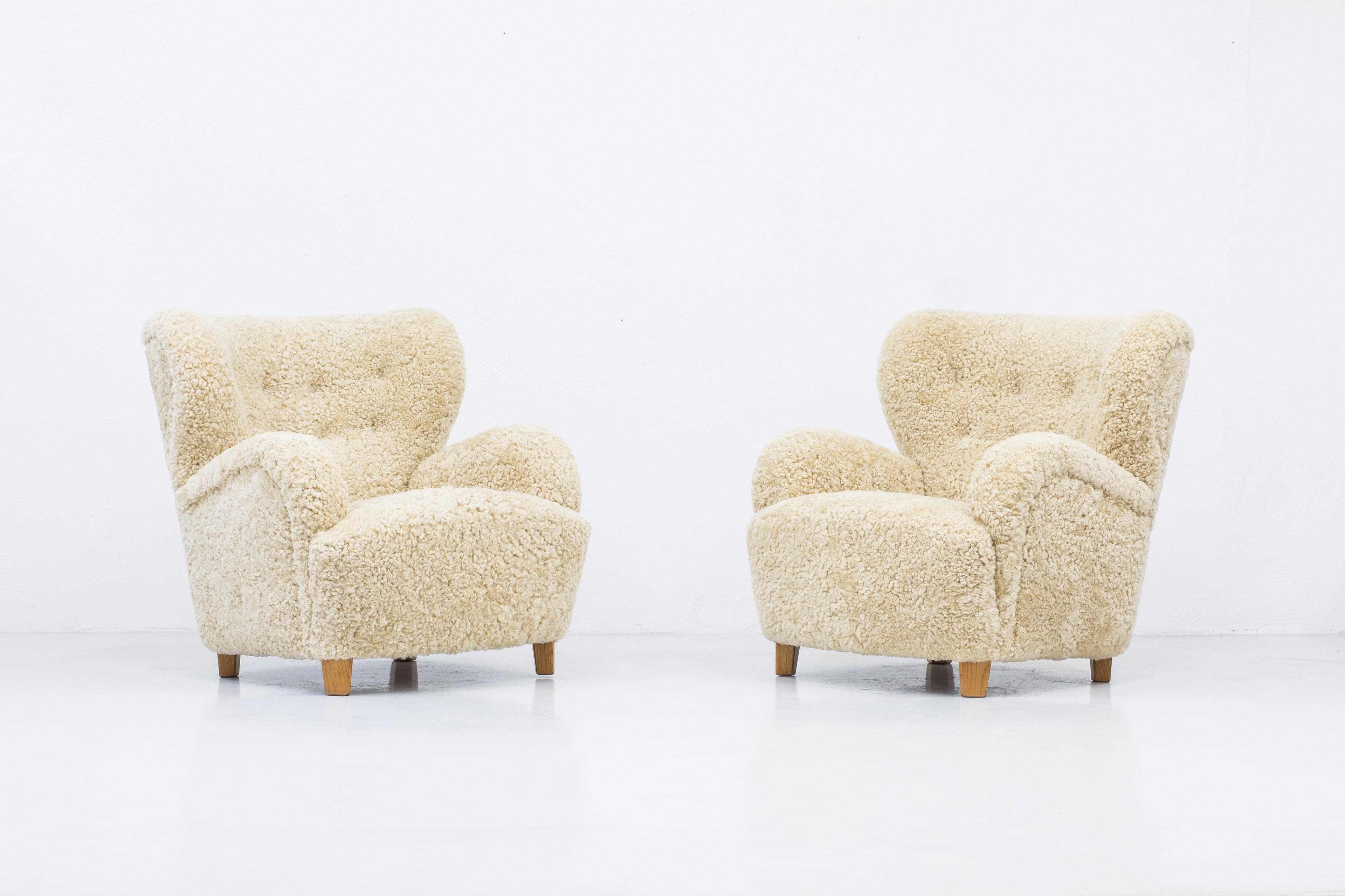 Danish modern sheepskin lounge chairs in the style of Flemming Lassen 9