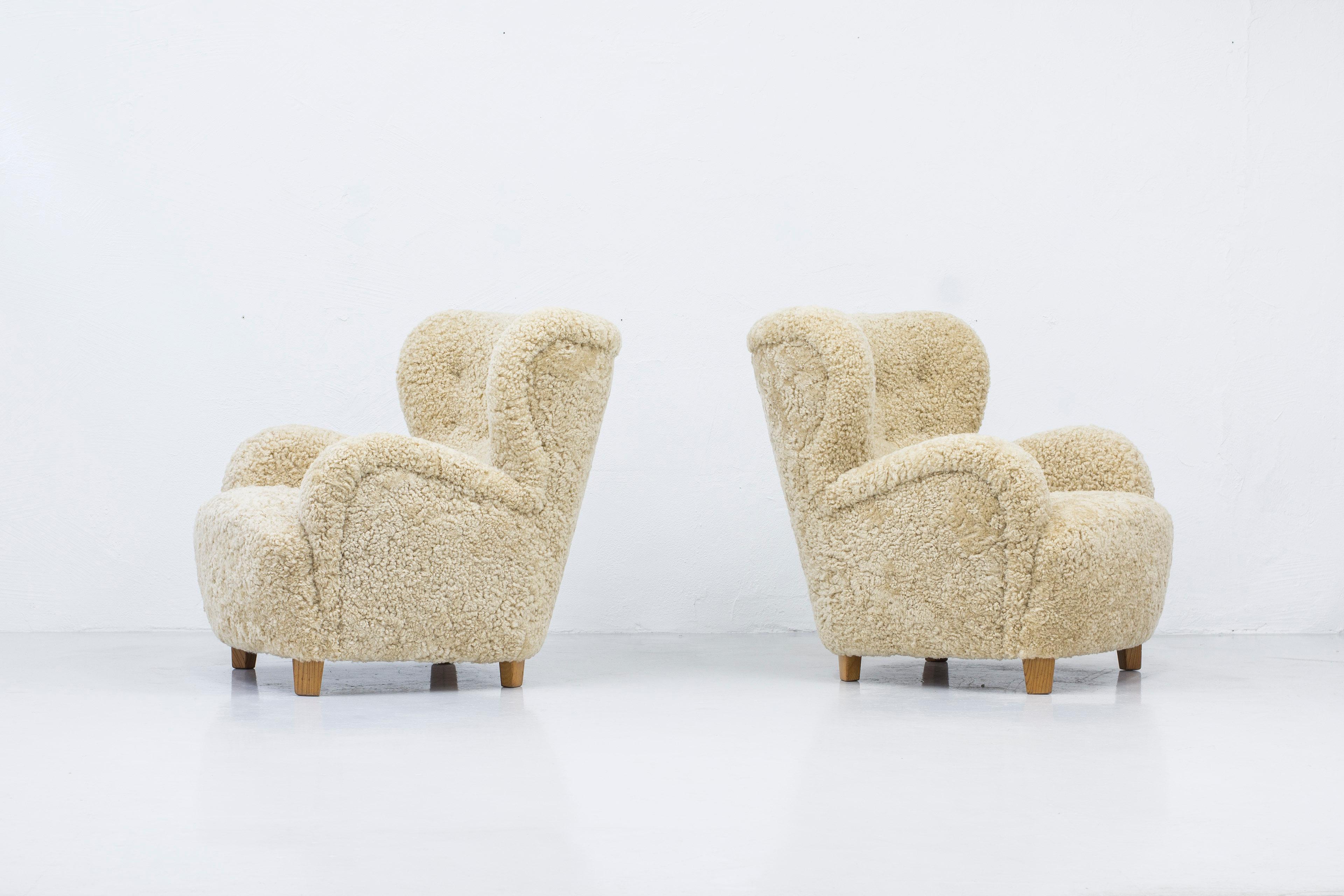 Scandinavian Modern Danish modern sheepskin lounge chairs in the style of Flemming Lassen