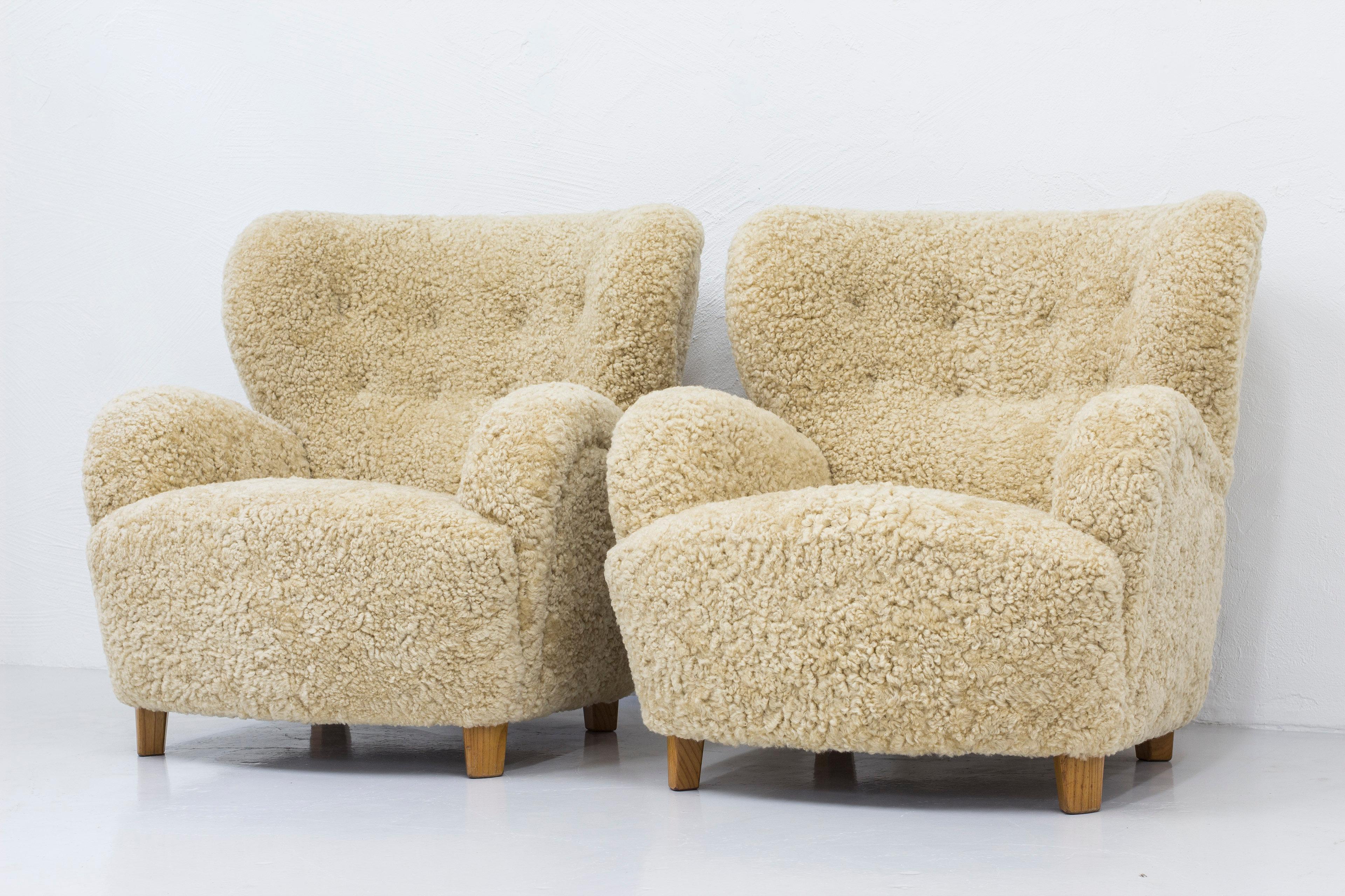 Mid-20th Century Danish modern sheepskin lounge chairs in the style of Flemming Lassen