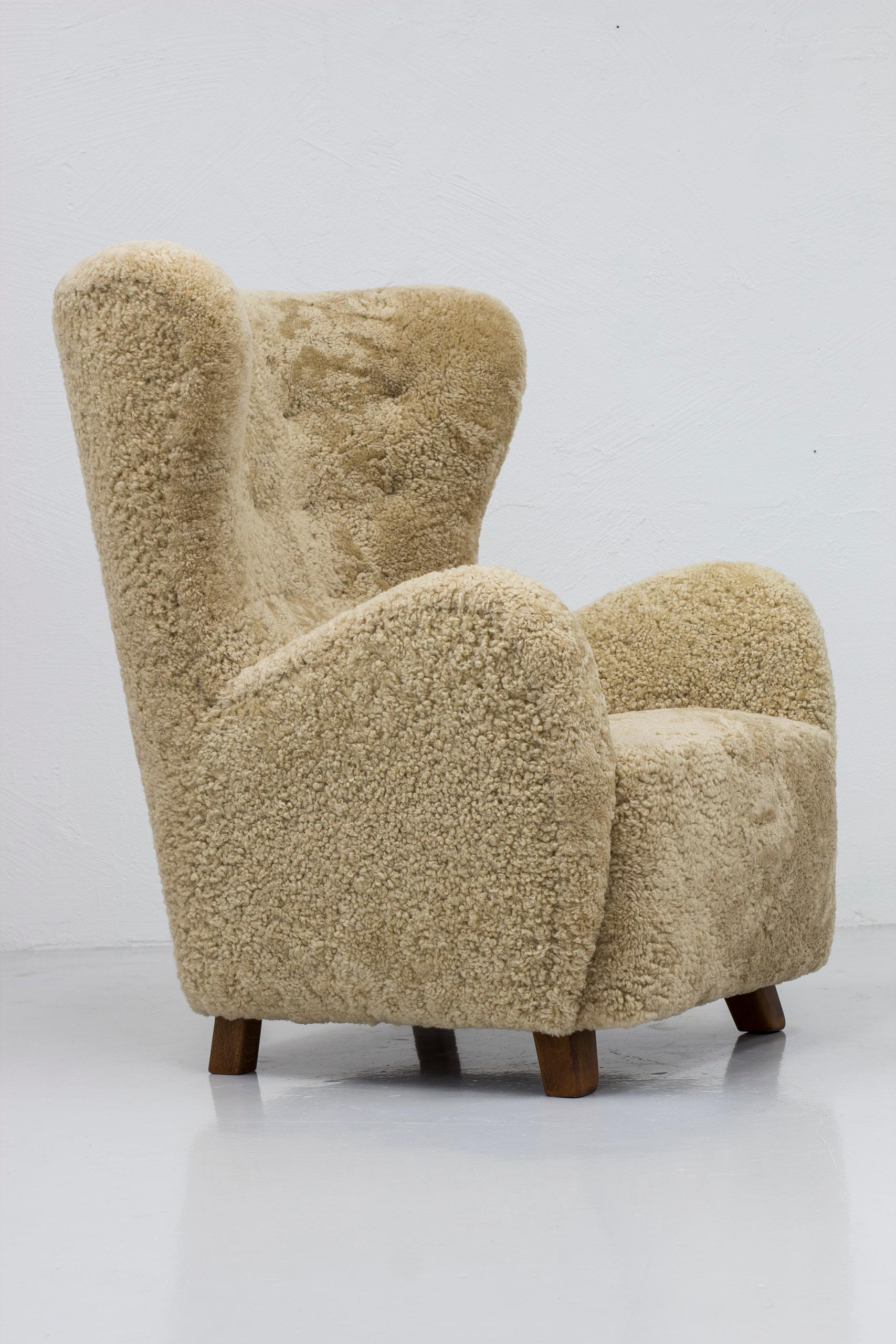 Sheepskin Danish modern sheepskin Wing back chairs attributed to Flemming Lassen, Denmark  For Sale