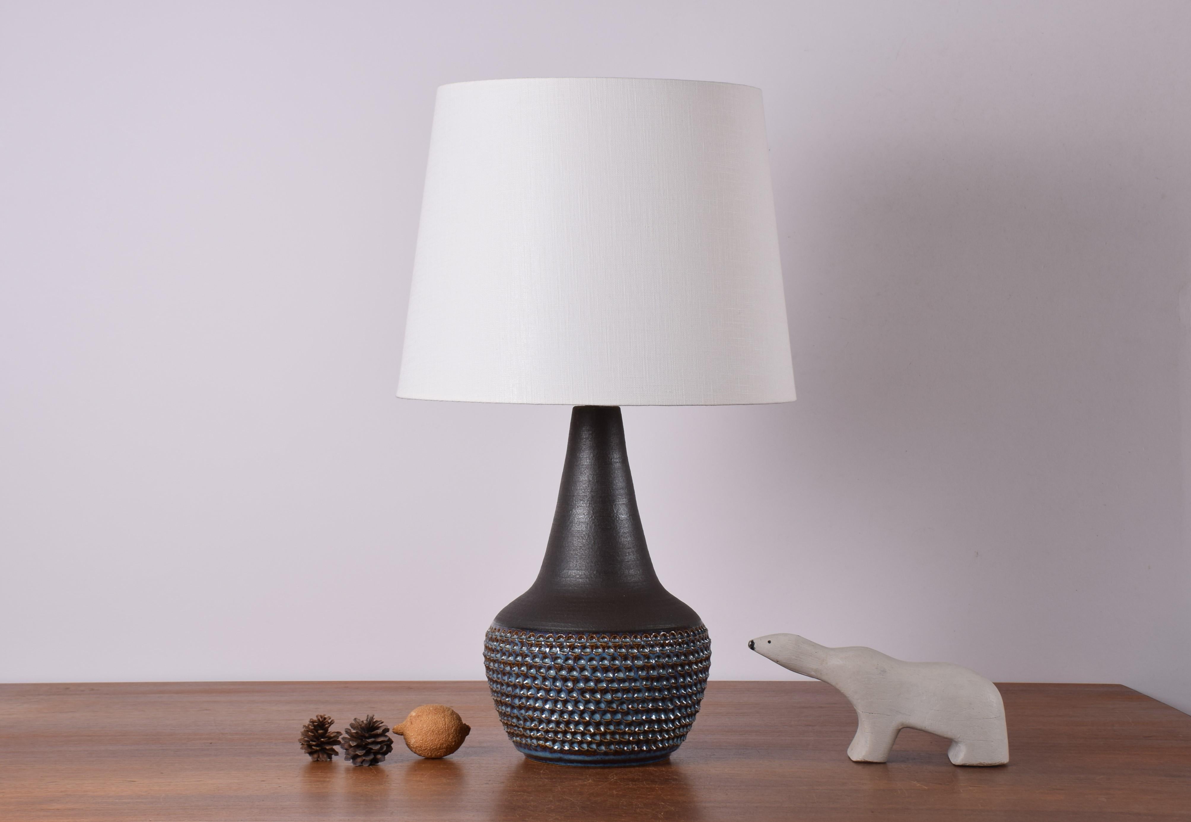 Midcentury tall budded table lamp designed by Einar Johansen for Danish stoneware manufacturer Søholm. Produced circa 1960s.

The lamp has a dark matte brown glaze on neck and shoulder contrasted by a textured surface and glossy bluish glaze on