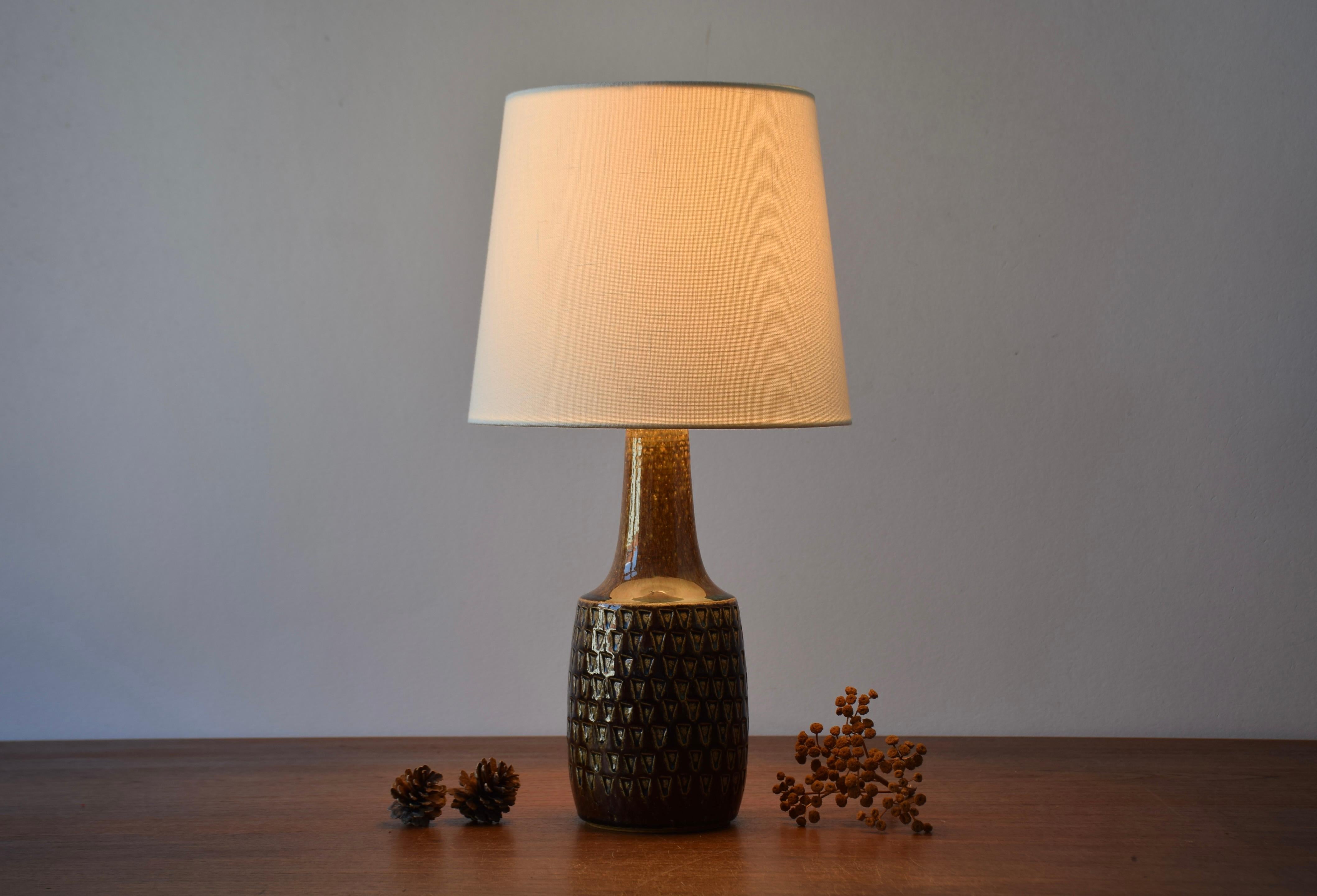 Ceramic table lamp manufactured by Søholm Stentøj, Denmark, circa 1960s. It features a shiny brown glaze on a textured body and has beautiful blue elements.

The lamp is marked on bottom with Søholm Bornholm Stentøj Denmark and number 3001.

The