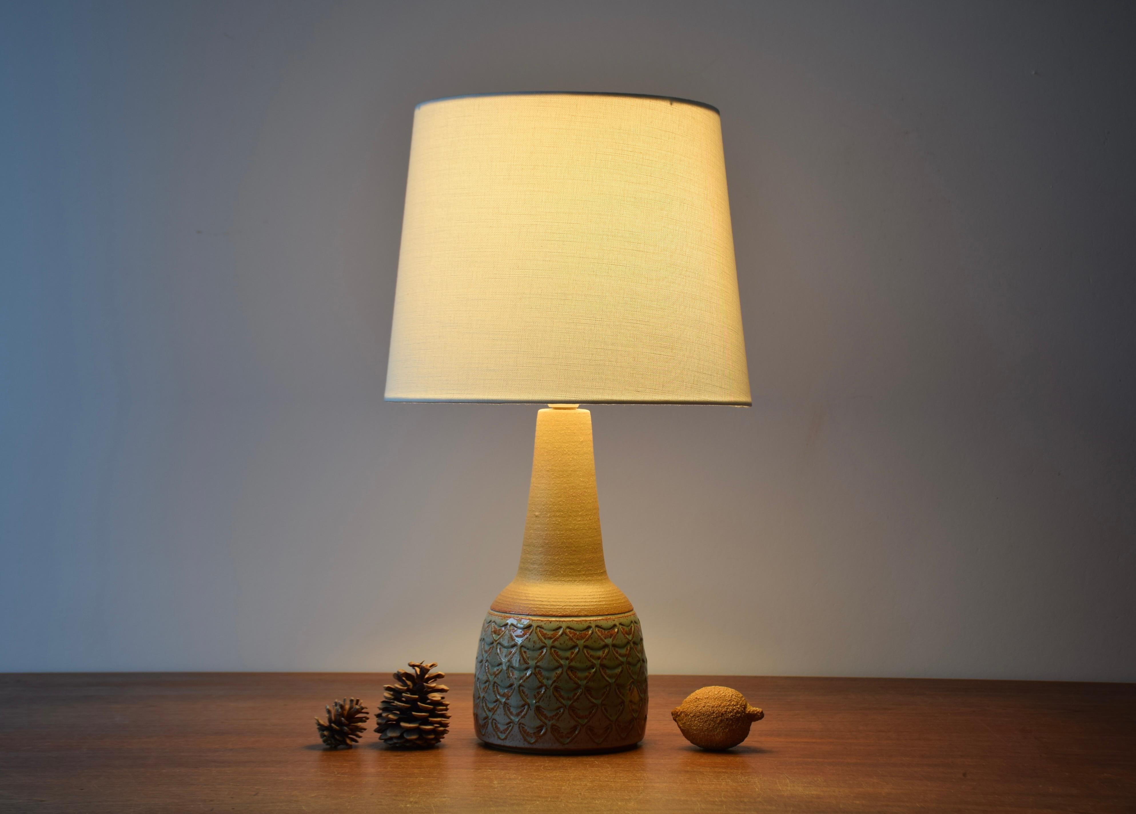 Midcentury Danish medium sized table lamp by Søholm Stentøj, Denmark. Made circa 1960s.
The lamp has repeated decor covered with a glossy pale green glaze and contrasted by an unglazed neck in warm brown. 

Included is a new lamp shade designed and