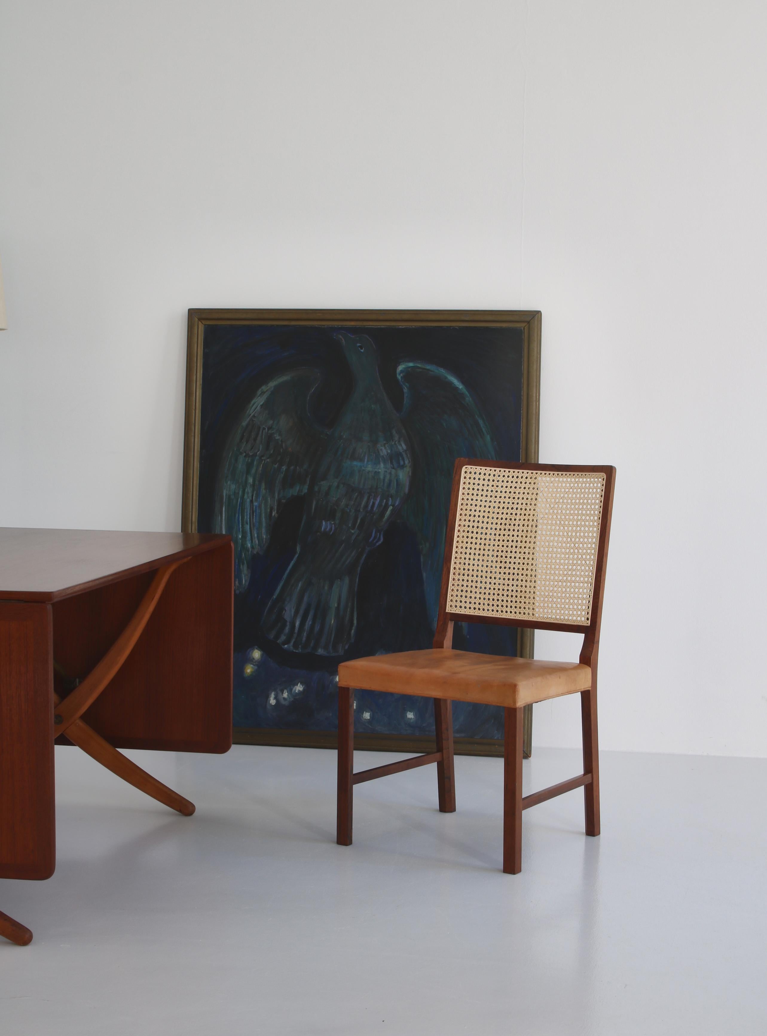 Elegant Danish Modern chair made by cabinetmaker Holger Nissen in the 1960s in his workshop in Denmark. The chair is made from solid rosewood with an amazing grain and the seat is upholstered in the original natural leather that has patinated evenly