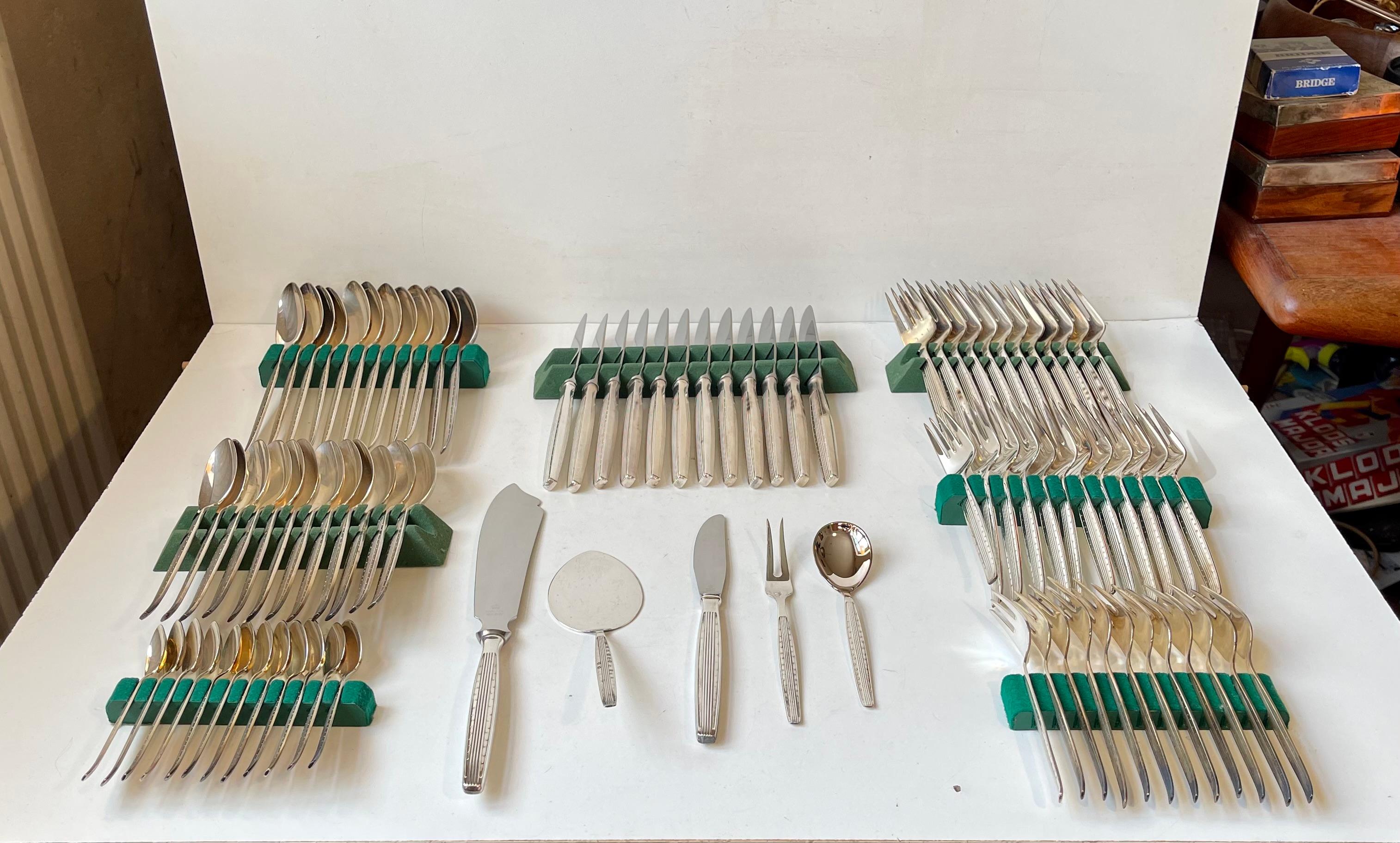 Extensive flatware cutlery set designed and made by Kristian J. Andersen - for his own company KJA in Fredericia Denmark during the 1960s. Stylistically its inspired from Art Deco architecture with its vertically fluted handles, stylish relief dots