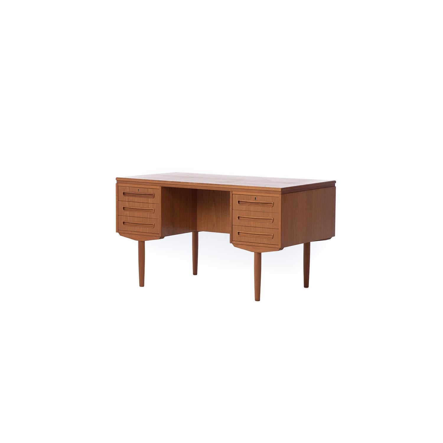 This Classic Danish modern desk is finished on both sides- 6 drawers with elongated organic shaped pulls and key-locking top drawers face the desk user while display/bookshelves and a drop front bar space face the hospitality side. This is an