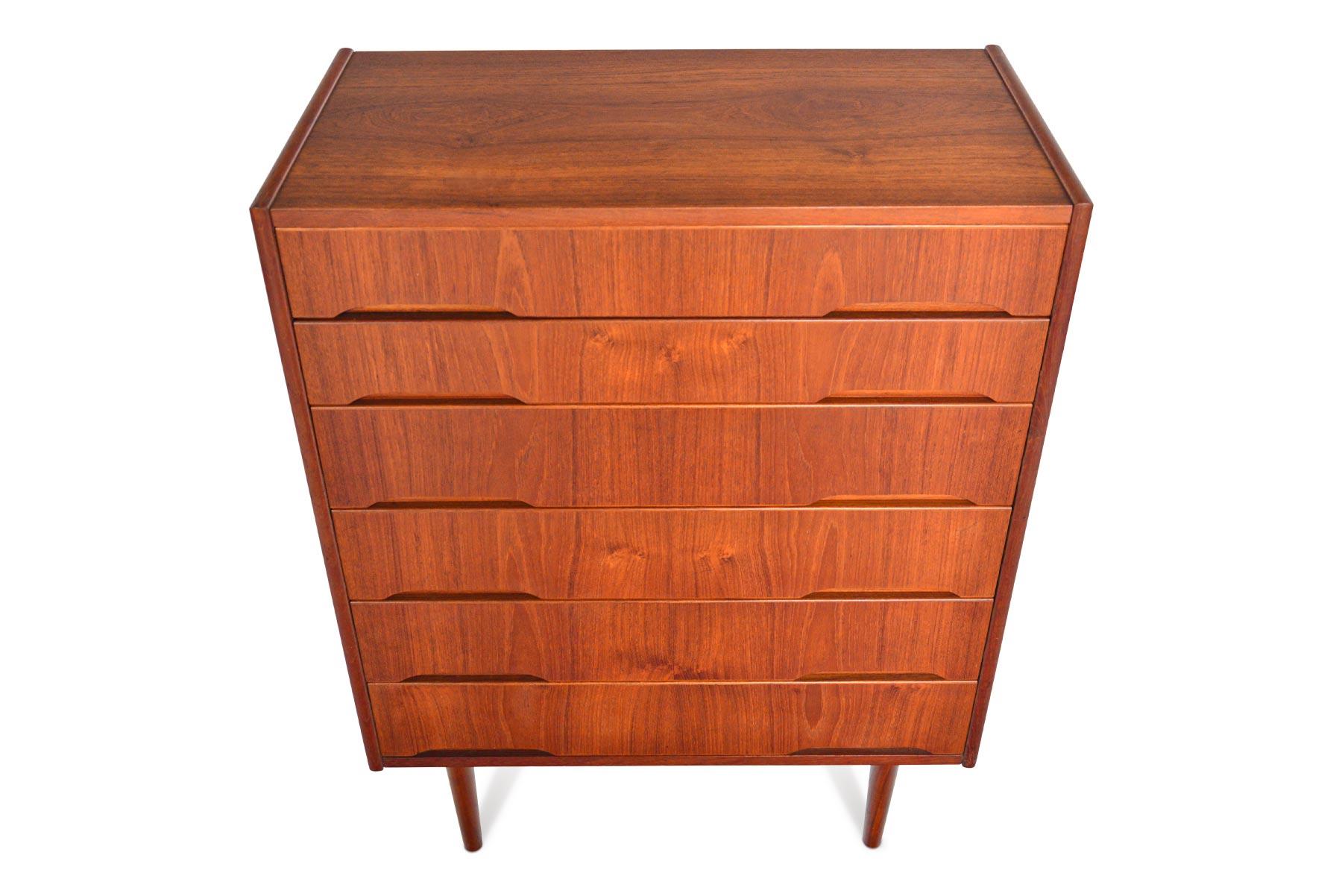 With a striking Minimalist design, this Danish modern teak highboy dresser offers simple details and clean lines. Two carved pulls line each drawer front. In excellent original condition.

 