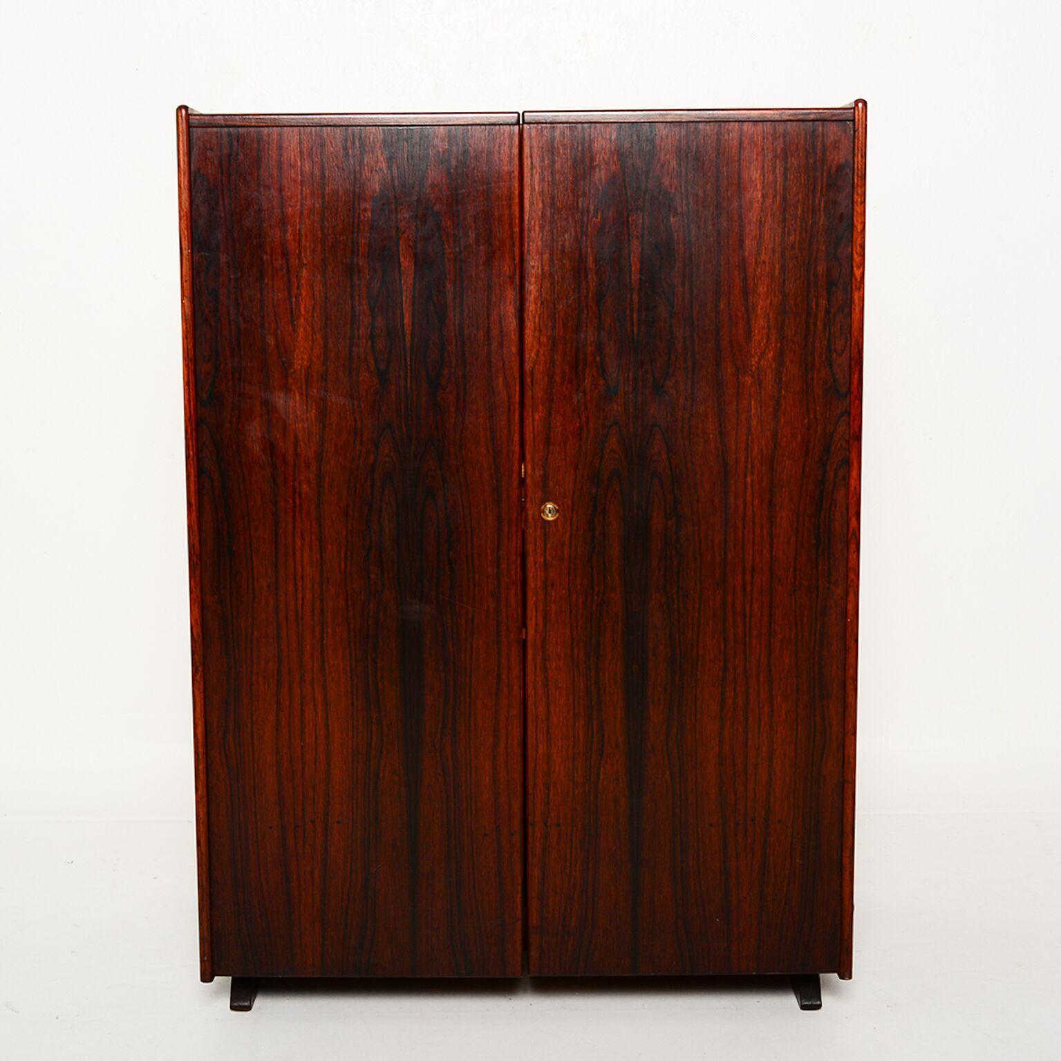 For your consideration a very rare and hard to find hideaway desk in exotic rosewood. When the desk is closed it shows a nice cabinet beautifully finished with exotic rosewood. Once you open the desk, the pull-out area showcases a large writing area
