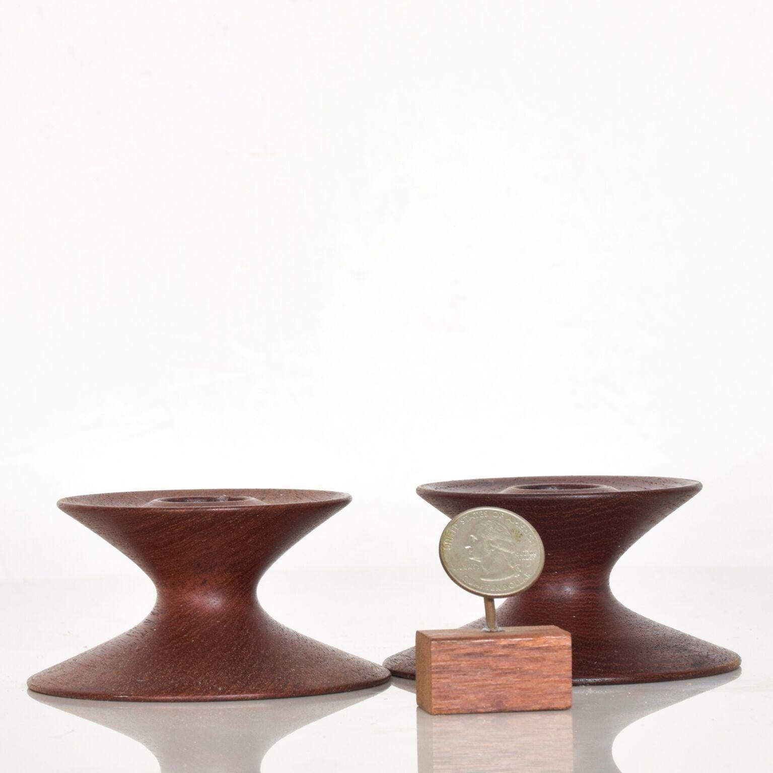 For your consideration: Danish modern elegant and sleek sculptural candleholders in teak dimensions: 1 3/4
