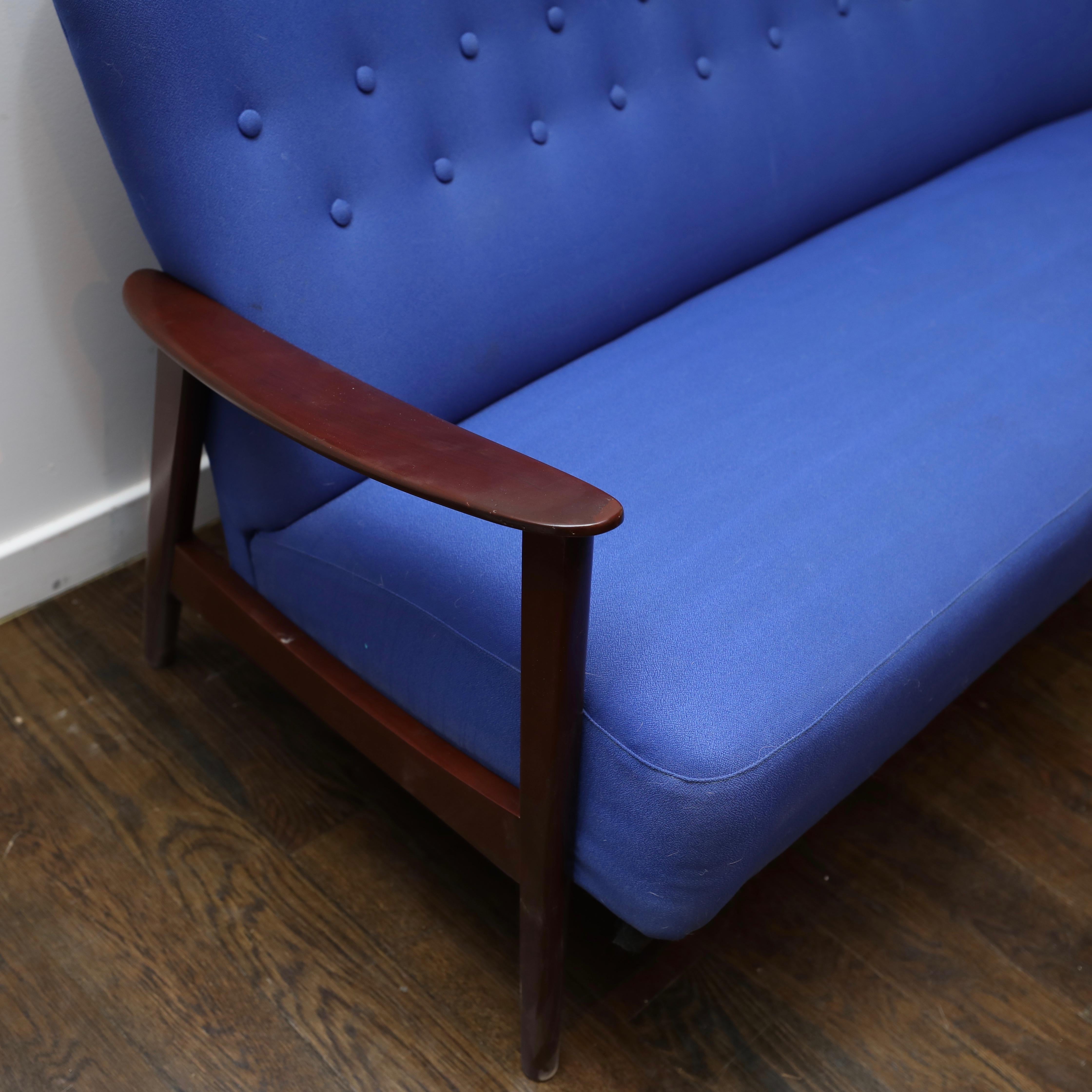 This is a fairly rare version by Danish designer Aksel Bender Madsen. Frame has been refinished in a dark walnut and prior damage to left arm shows slightly through. Periwinkle colored upholstery is more than presentable.
Aksel Bender Madsen, often