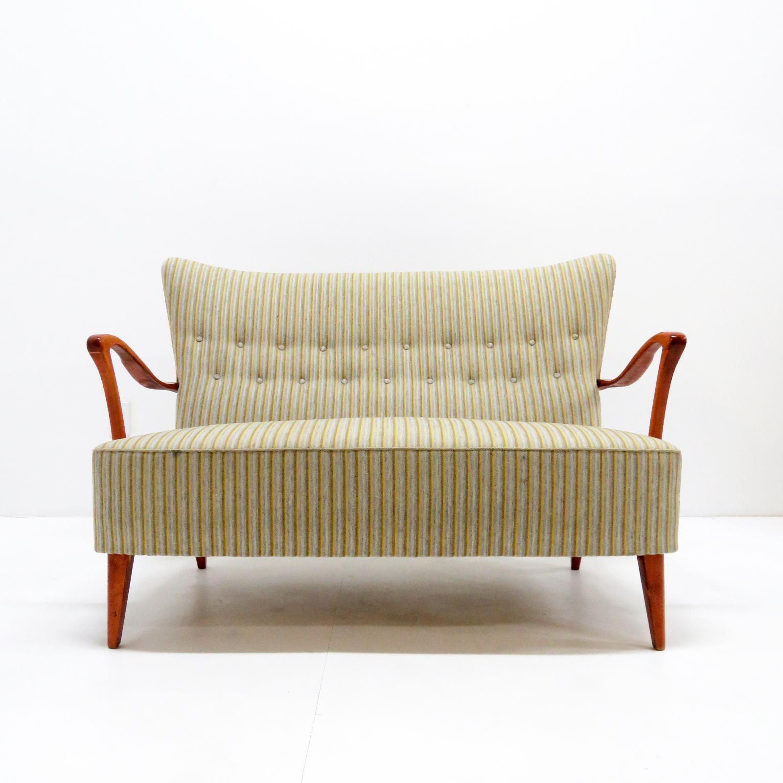 Wonderful Danish modern sofa, settee by DUX, sculptural stained and lacquered beech frame with a multicolored, striped upholstered body, The concave wing-back is tufted and the seat is spring supported, marked. (see also LU848715416872 and