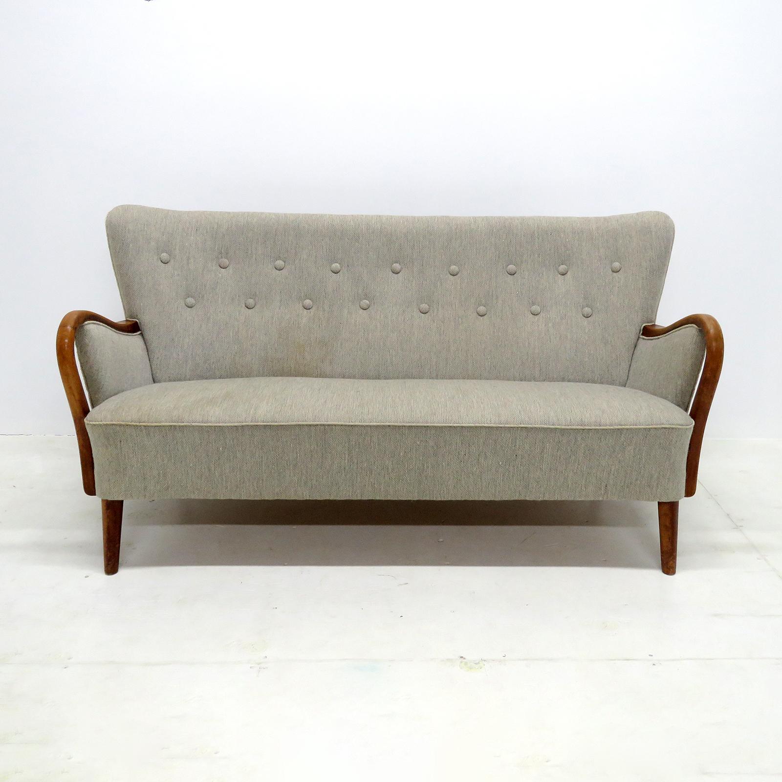 Wonderful Danish modern sofa, settee by DUX, sculptural stained and lacquered beech frame with a grey wool upholstered body, The concave wing-back is tufted and the seat is spring supported.