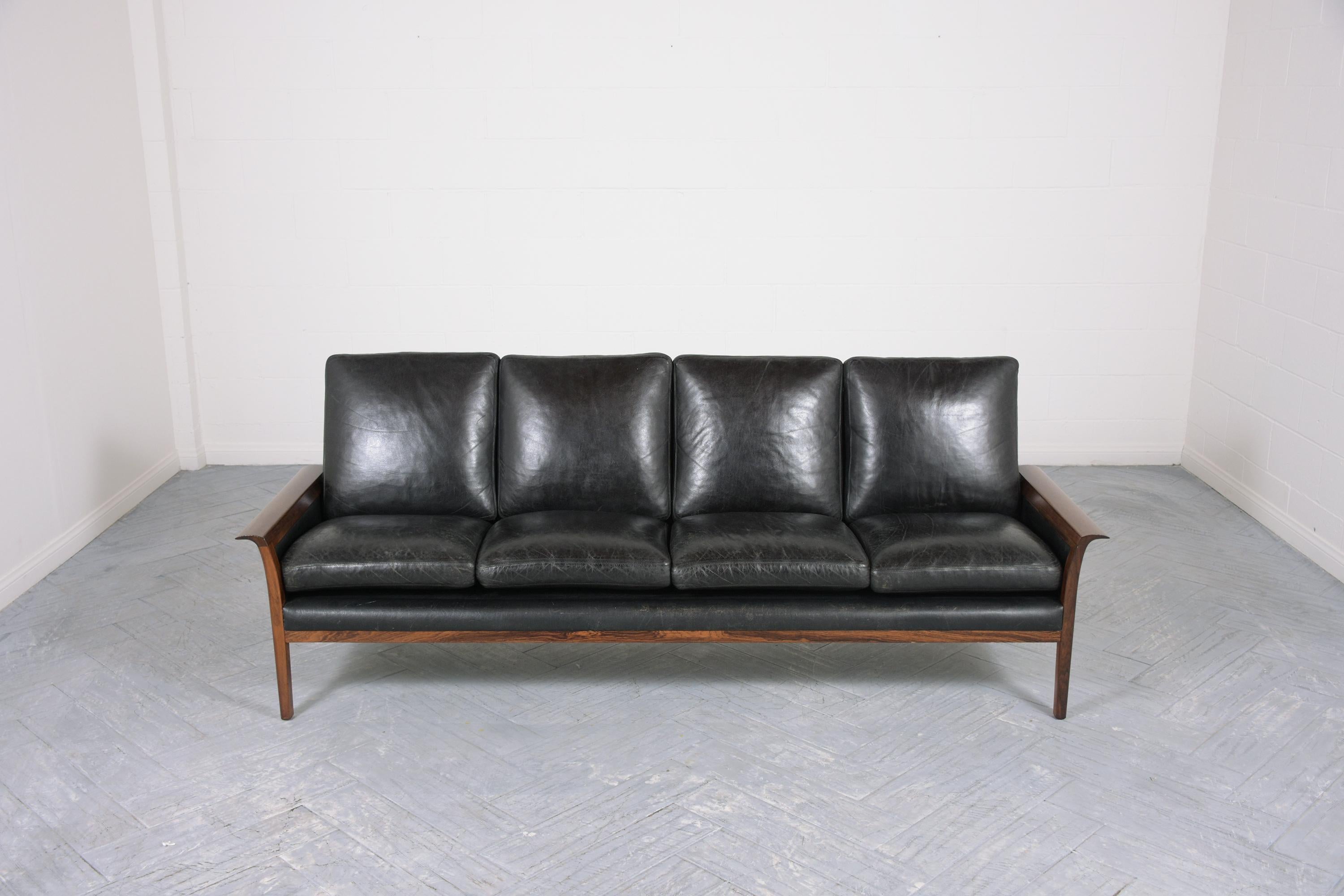 This extraordinary modern danish executive sofa by Illum Wikkelsø is hand-crafted out of rosewood & leather combination in great condition and has been completely restored by our professional craftsmen team. This sofa is eye-catching featuring a