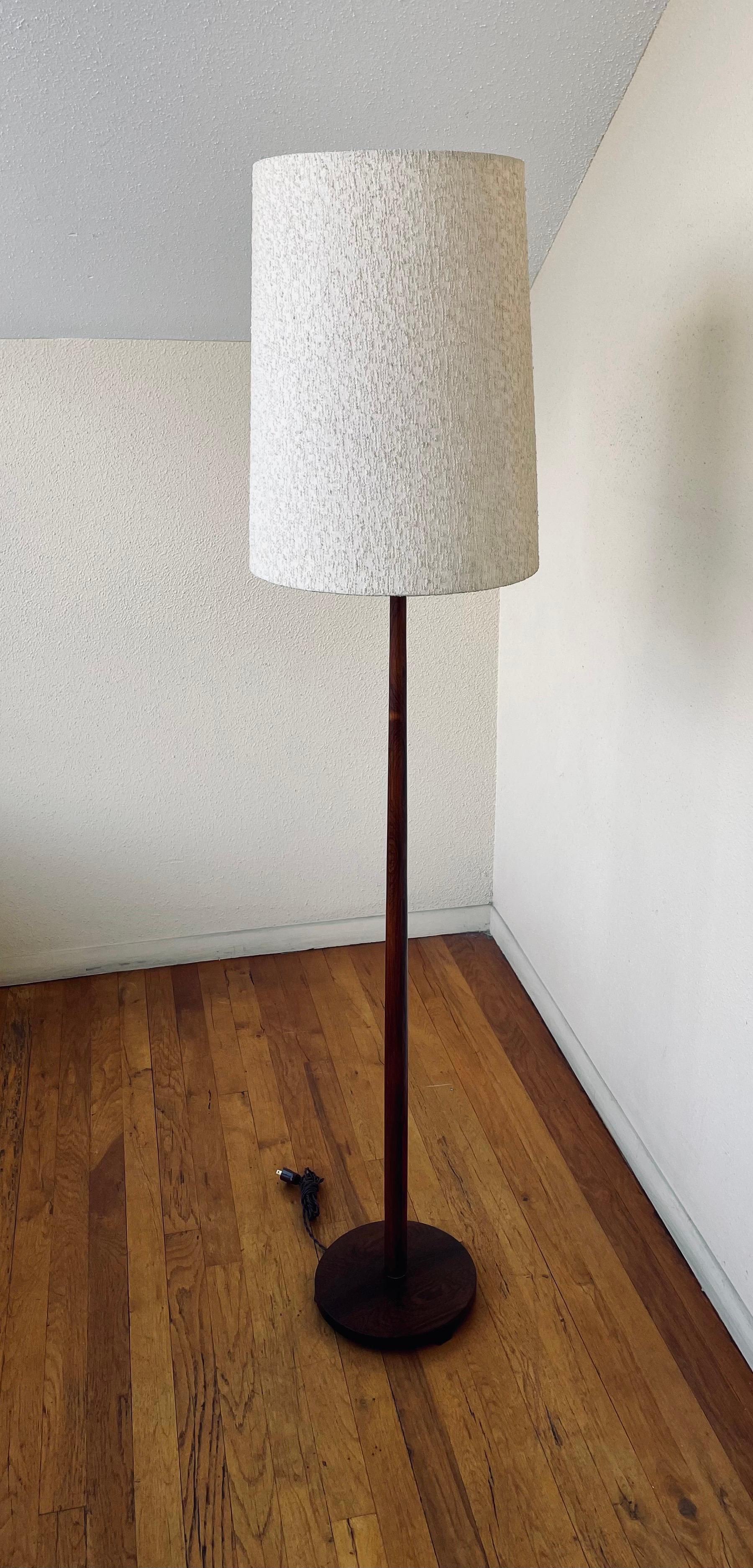 A beautiful and rare solid rosewood floor lamp, excellent condition freshly refinished and rewired with a new cloth cord., made in Sweden, and perfect working condition. The lampshade is not included due to shipping expenses it's not worth shipping
