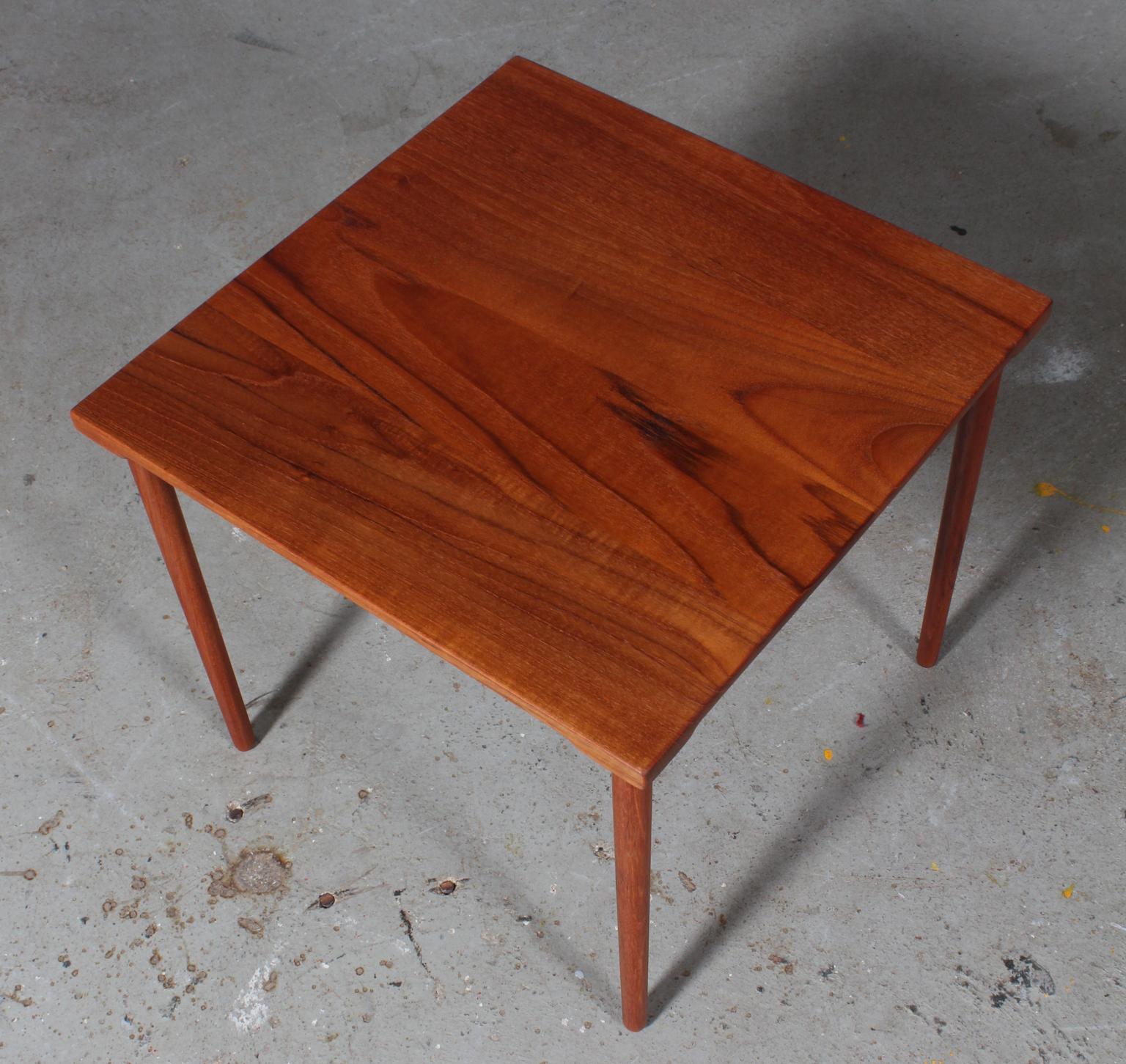 These lovely and Minimalist Danish modern teak side tables were designed by Peter Hvidt & Orla Mølgaard-Nielsen in the 1960s for France & Daverkosen / France & Son. Made entirely of solid teak, the top has gorgeous grain, and each side has an arced