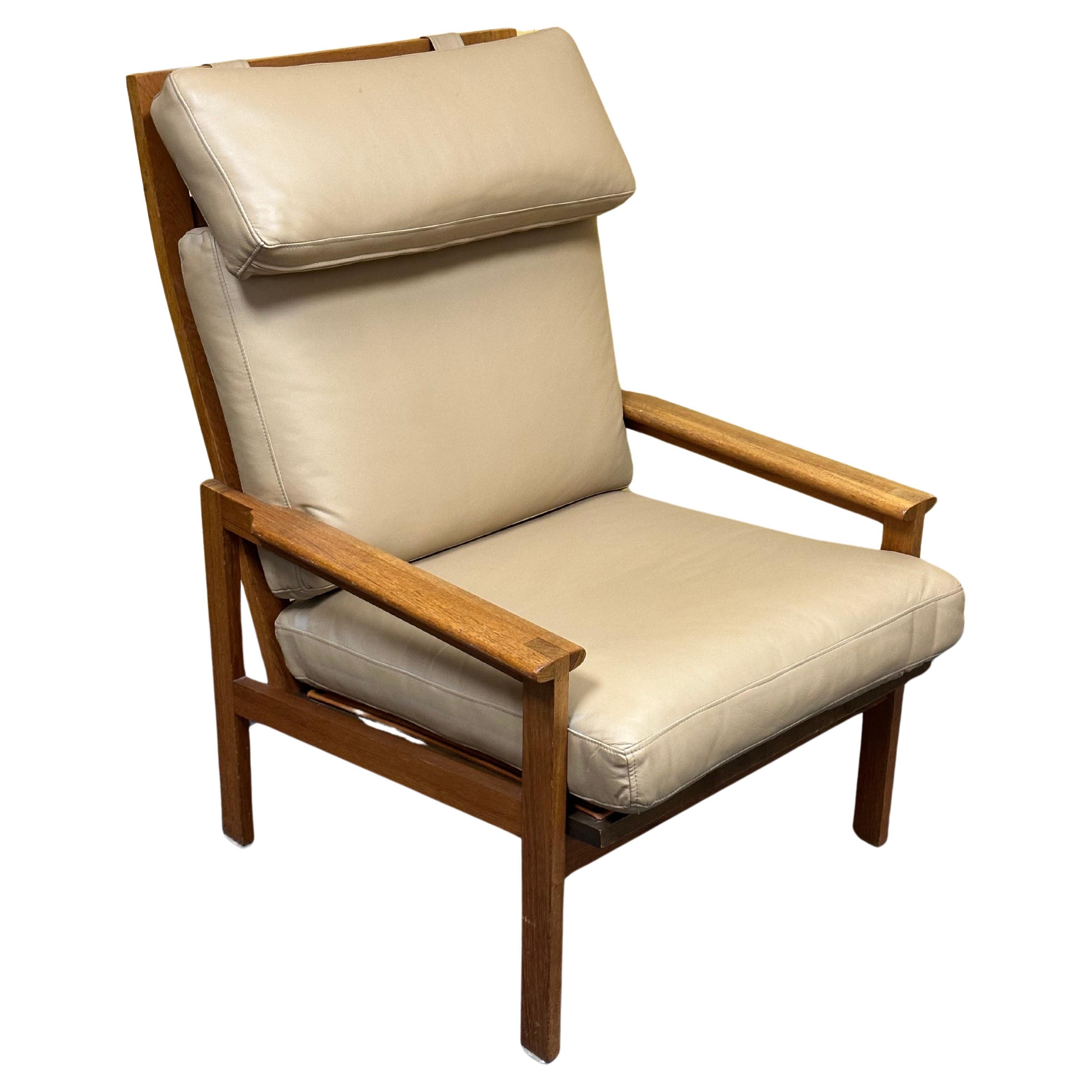 Striking Danish modern solid teak and leather high back armchair by Niels Eilersen, circa 1970s. The chair is in very good vintage condition and measures 26.5