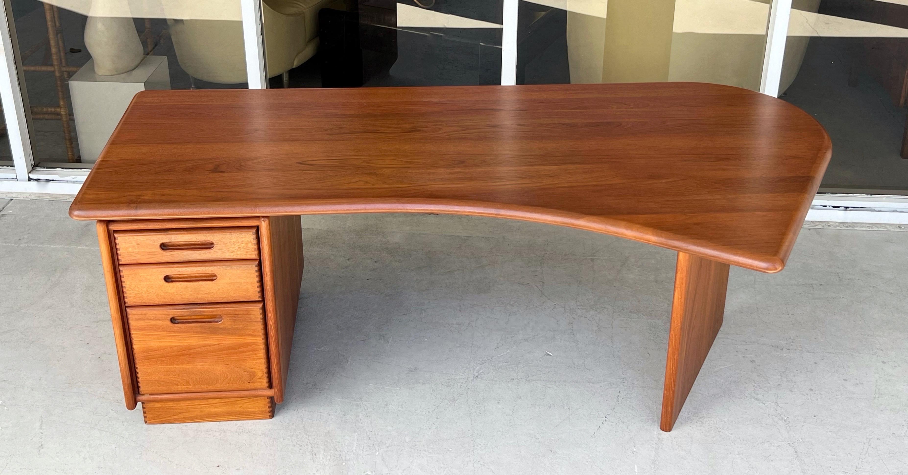 A rare Danish Modern Desk with a biomorphic top. Solid teal construction. 
Note the finger joints on all drawers. 