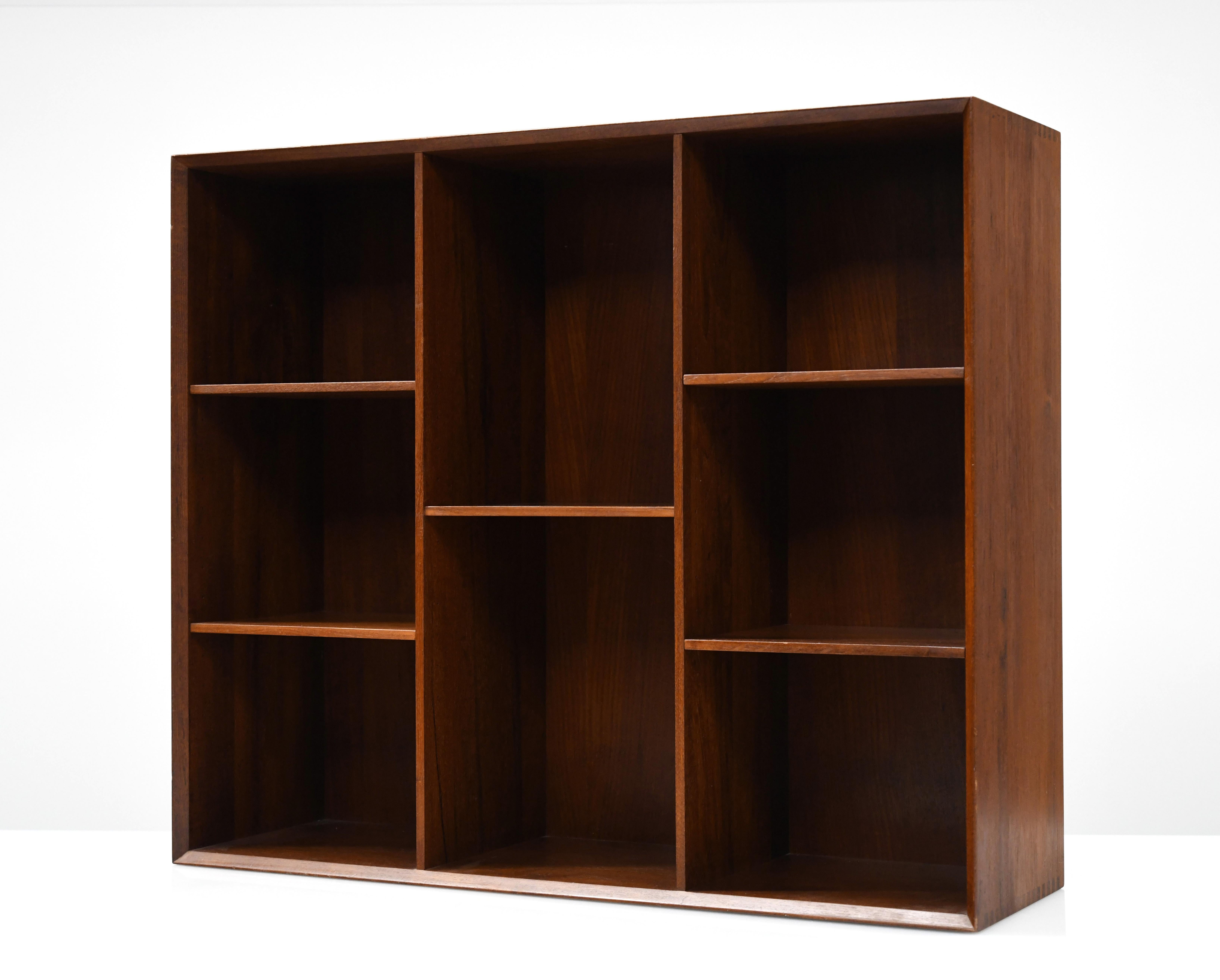 Beautifully constructed bookcase by Peter Hvidt and Orla Mølgaard-Nielsen. Cabinet is made from solid teak with exposed finger joined details. The bookcase has developed a nice even patina. Bookcase was originally acquired in Denmark in 1962. Case