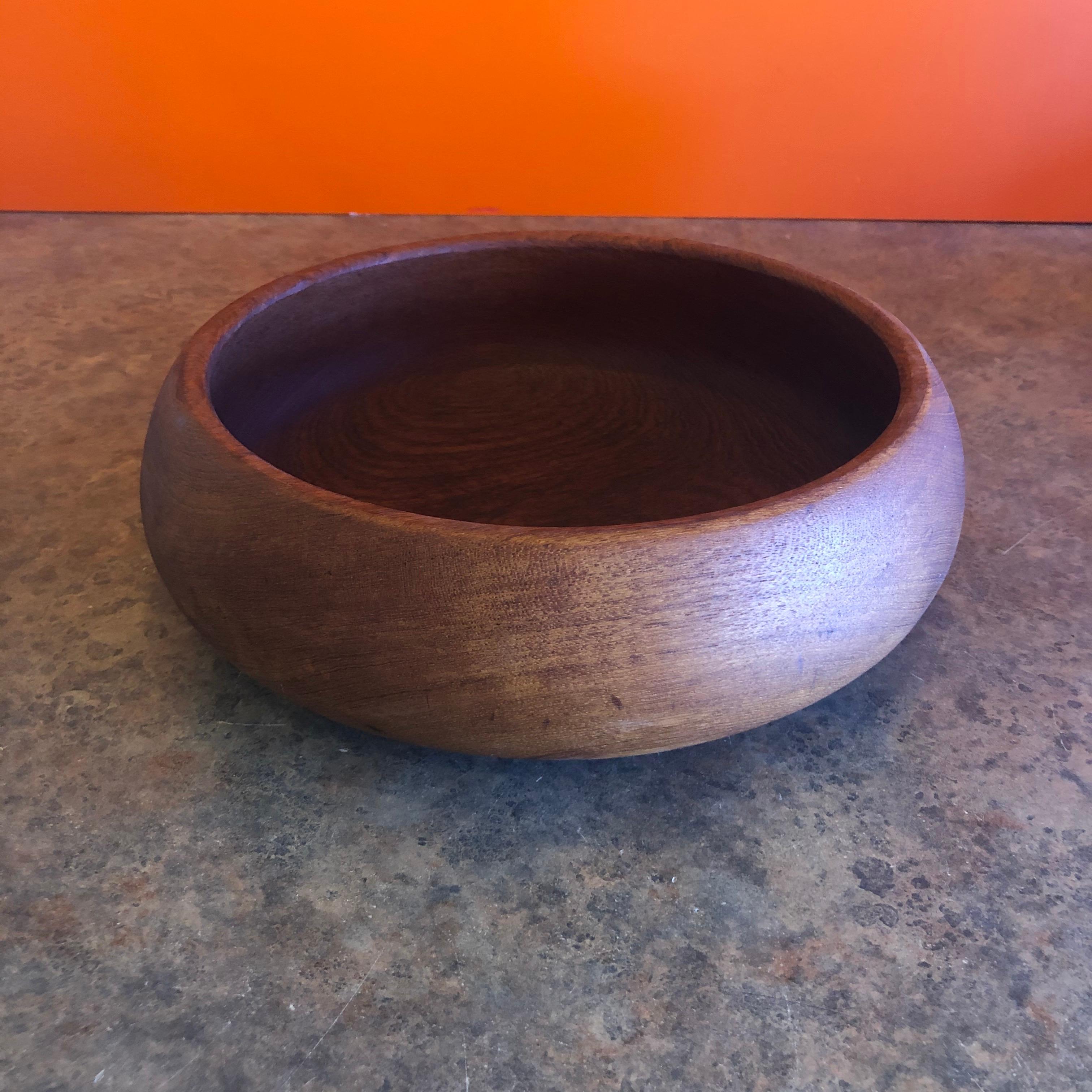 A beautiful Danish modern solid teak bowl in the style of Jens Quistgaard for Dansk, circa 1970s.