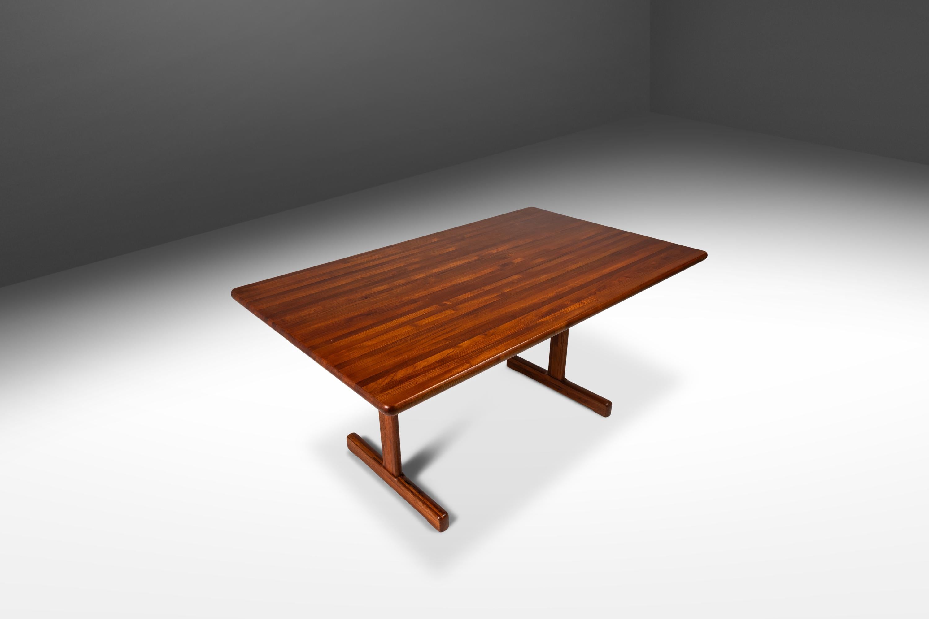 Simultaneously understated and visually arresting this gorgeous Danish-made table is the epitome of Danish Minimalism. Constructed entirely from solid Burmese teak from top to bottom featuring out-of-this-world woodgrains, colors and patterns this