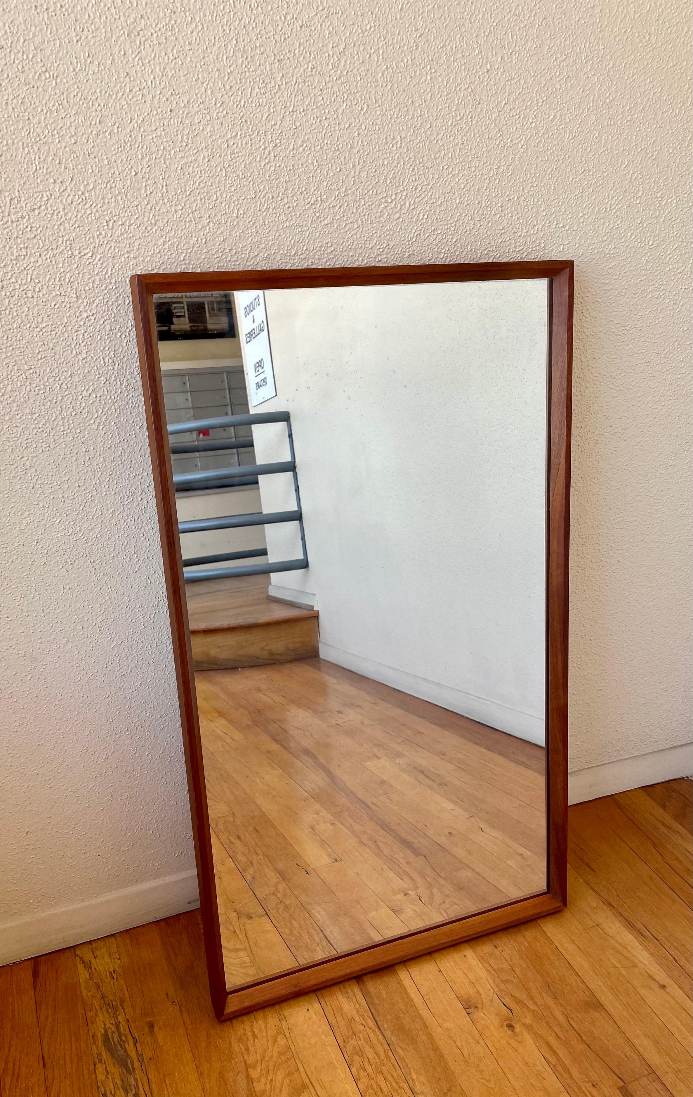 Beautiful, sleek, rectangular mirror with a solid teak frame Attributed to Pedersen & Hansen of Denmark. Superb quality and craftsmanship; the mirror is finished with a nice beveled edge. The mirror can be easily hanged horizontally or vertically.