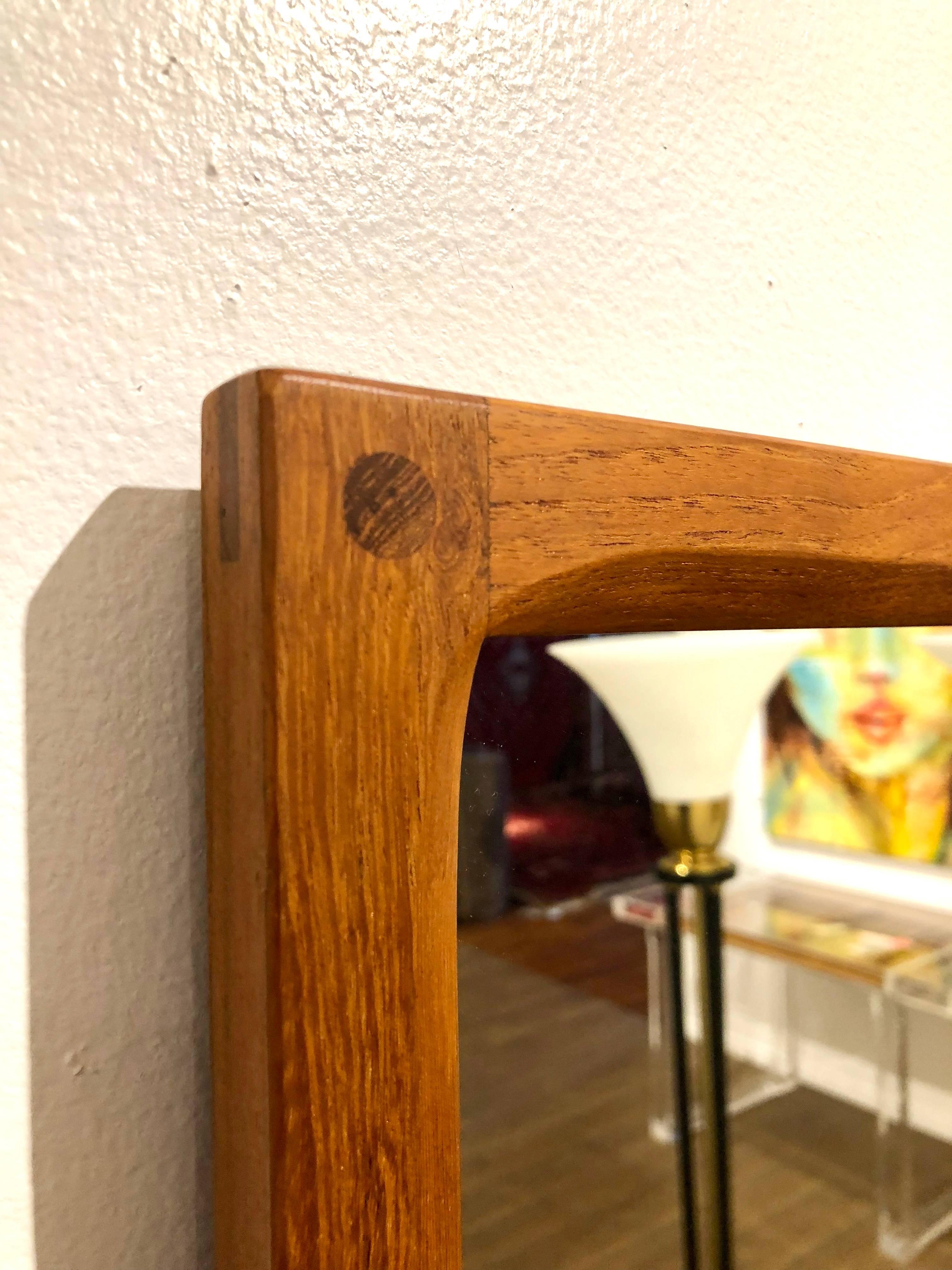 A great designed mirror by Aksel Kjersgaard, circa 1950s great craftsmanship unique design solid teak mirror frame. Signed in the back can be hang vertical and horizontal.