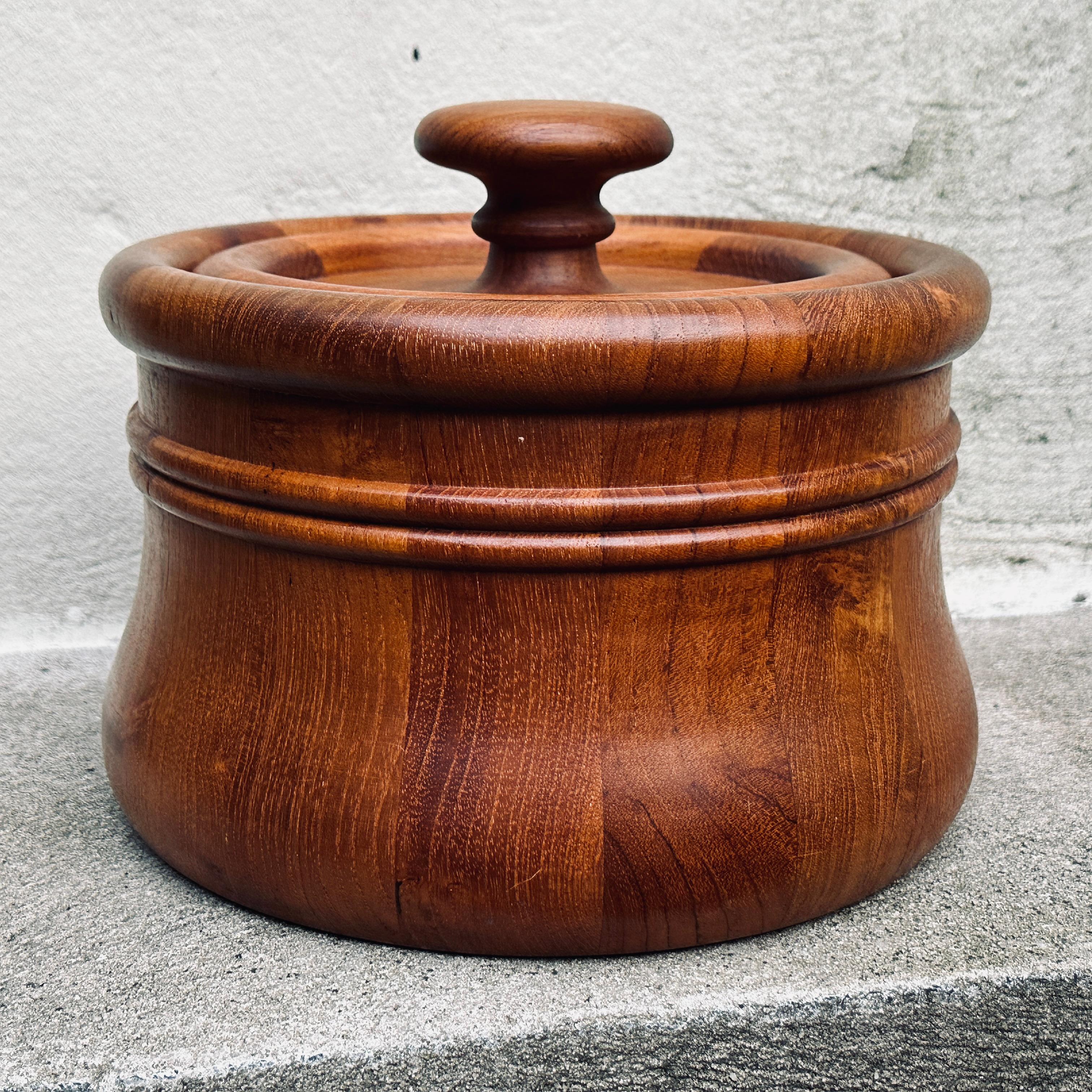 Mid-Century solid teak lidded ice bucket by Richard Nissen, Denmark. This piece displays a unique sculptural and heavily turned shape and has the original orange plastic liner intact. Maker's mark on underside. 
