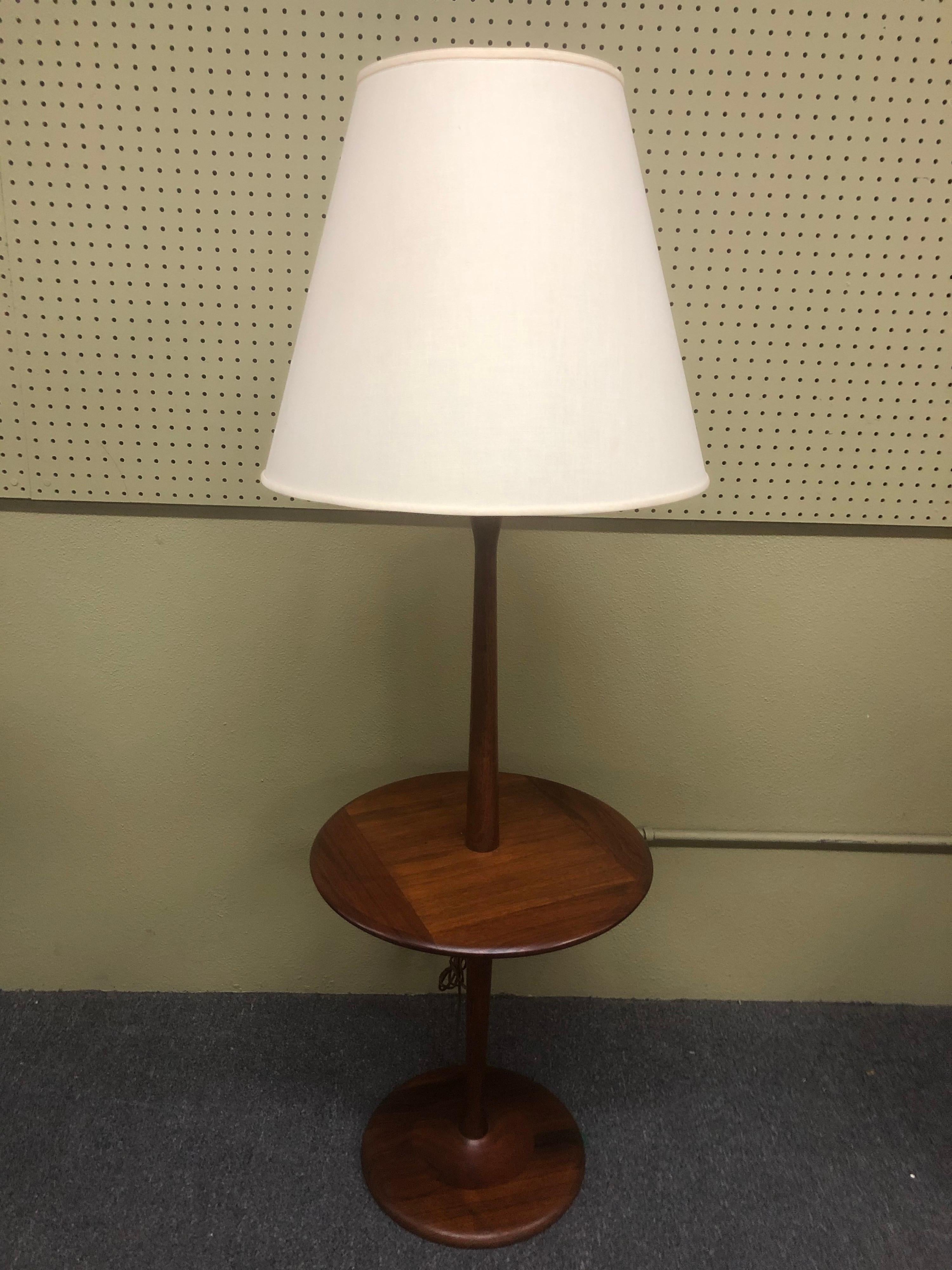 Simple and elegant Danish modern solid teak table and floor lamp, circa 1960s. The lamp is in very good vintage condition with the original shade; the piece measures 18.5