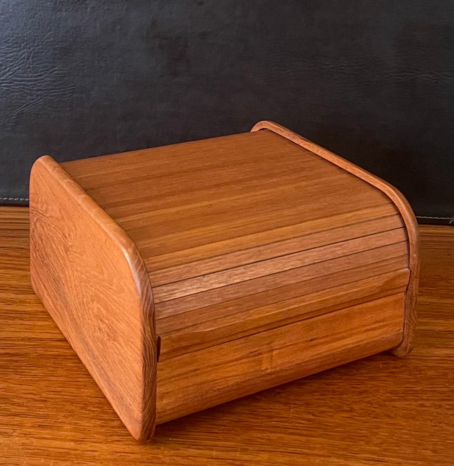 A very nice Danish modern solid teak tambour door box, circa 1970s.  The box is in very good vintage condition and measures 9.75