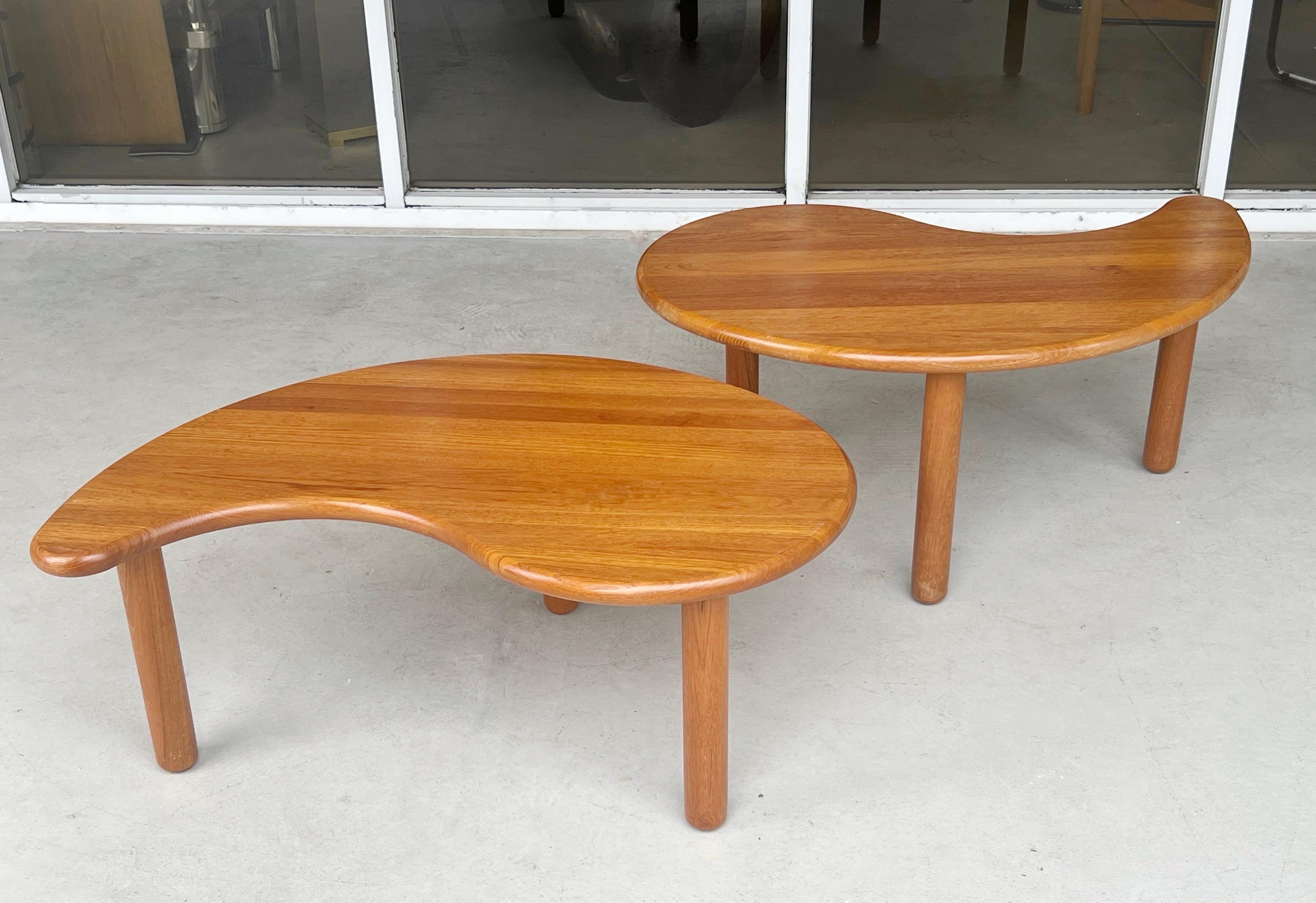 Unusual coffee table. its actually a two part in the Jing Jang design. One table is actually tall enough to allow the lower table to go under a little bit. Each with 3 solid cylindrical legs that screw to the top.
